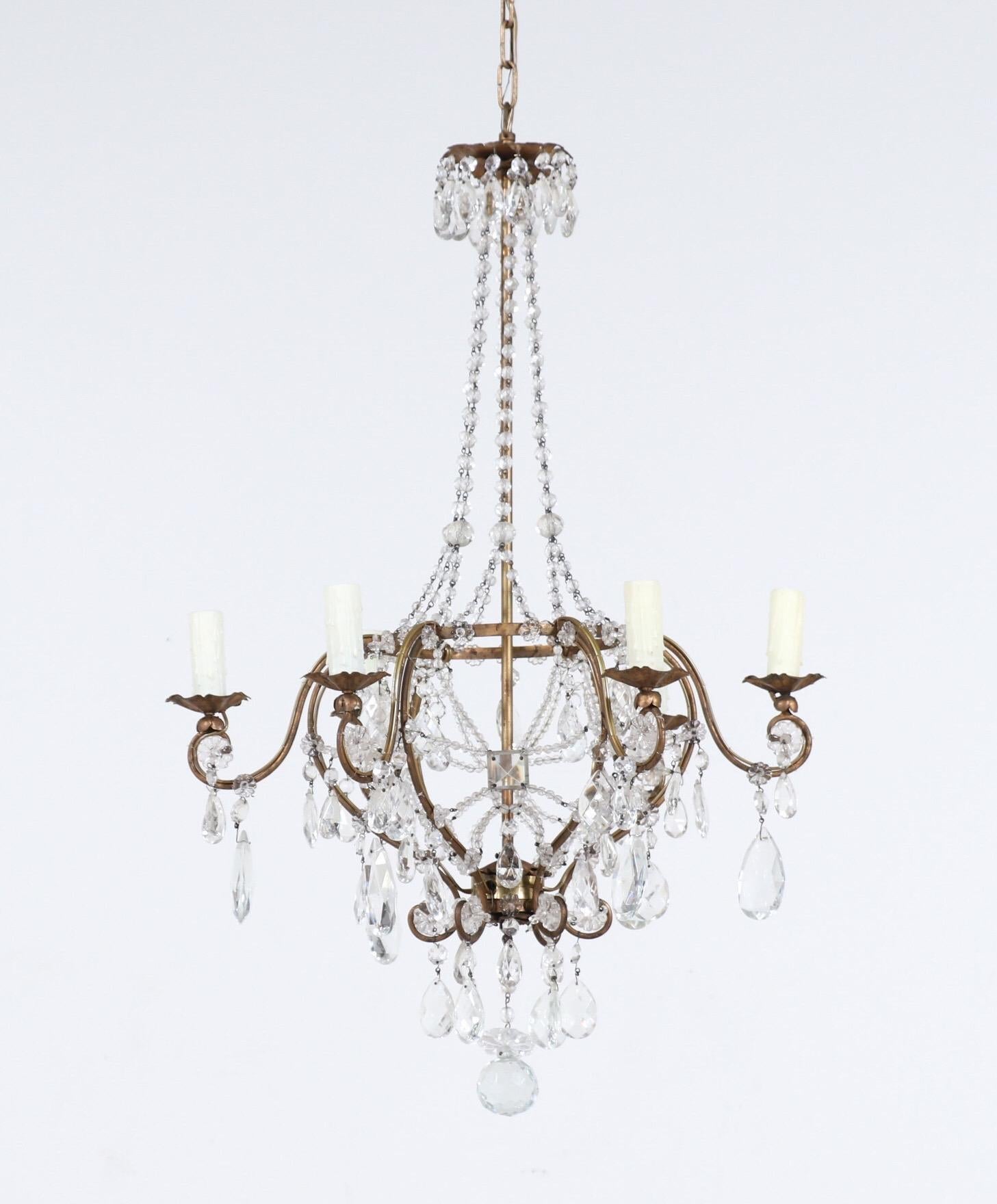 Beautiful, 1940s Italian gilt-iron and crystal beaded chandelier.

This chandelier features a delicately shaped wrought iron frame with intricate crystal beaded decorations. The chandelier is wired and in working condition, it requires 6