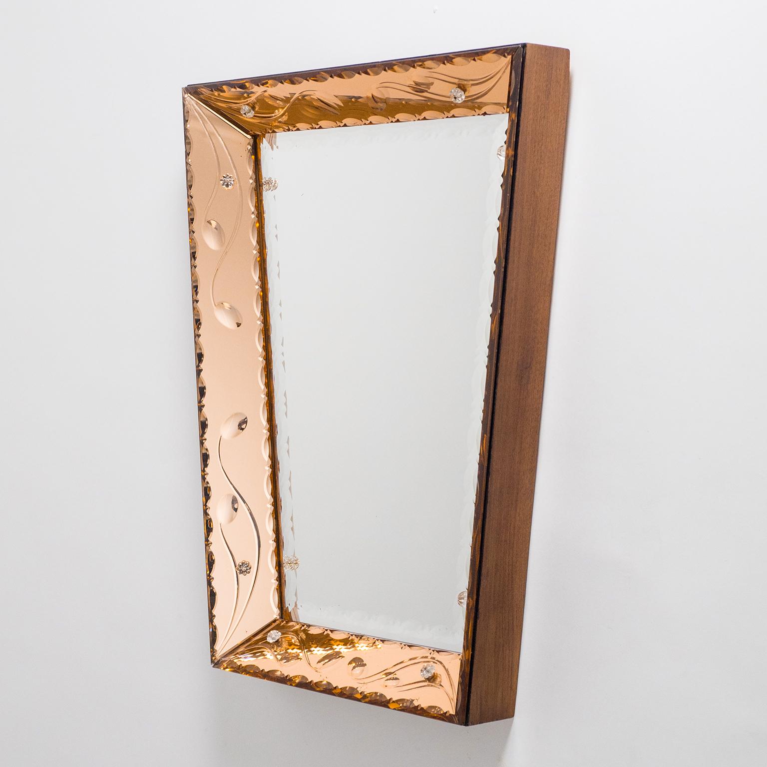 Beautiful Italian trapeze mirror with dual color mirrors. Inserted into a deep wooden frame are sheets of cut crystal glass in a copper or rose color as well as a clear mirror. Each of these are intricately beveled, scalopped and cut with abstracted