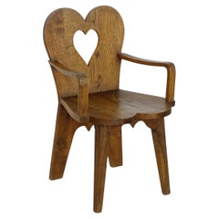 Italian 1940s folk art oak armchair with heart cut back