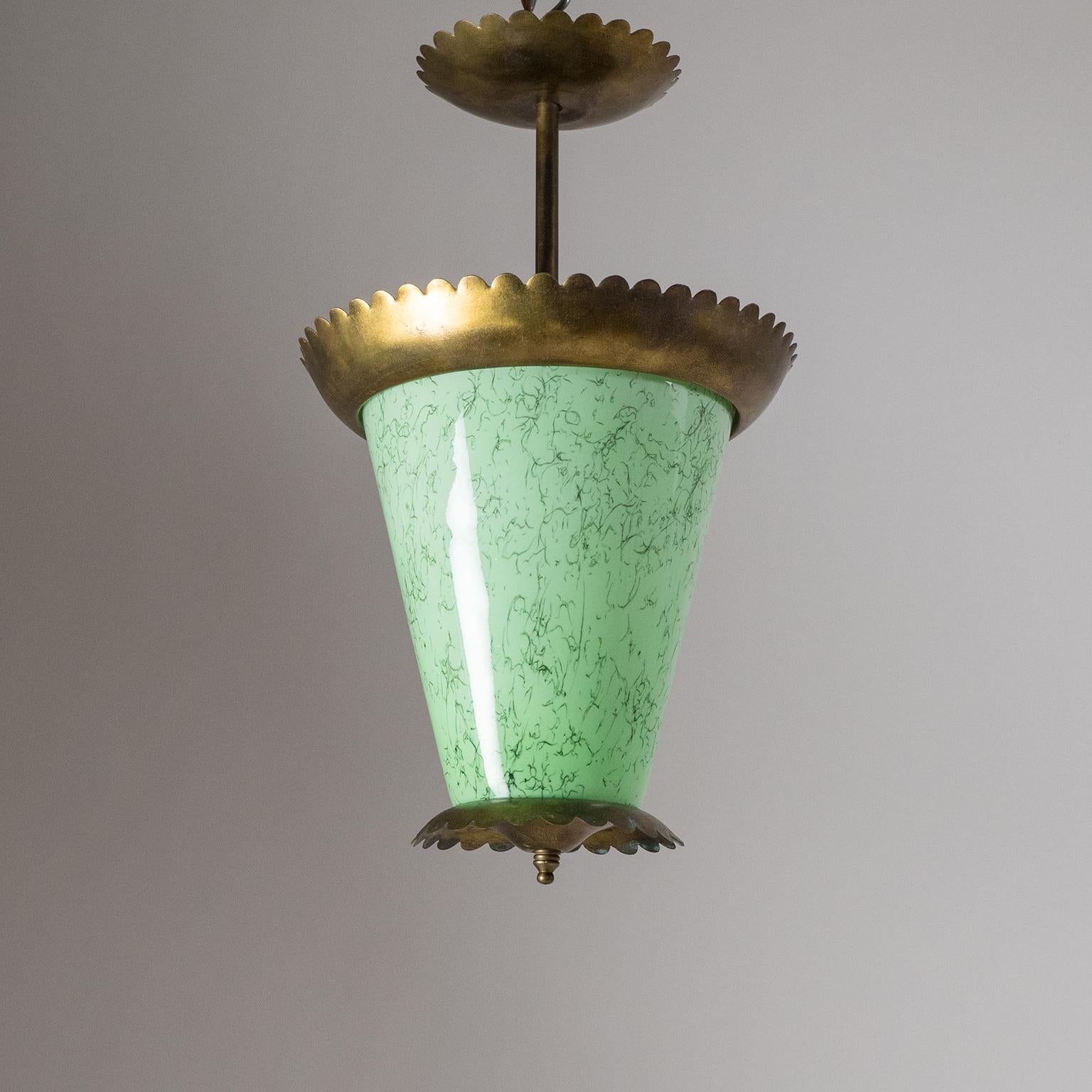 Charming Italian brass ceiling fixture from the 1940s. Very unusual Murano glass diffuser with layers of green, white and clear glass with inclusions. Fine original condition with patina on the brass. Three original brass and ceramic E14 sockets