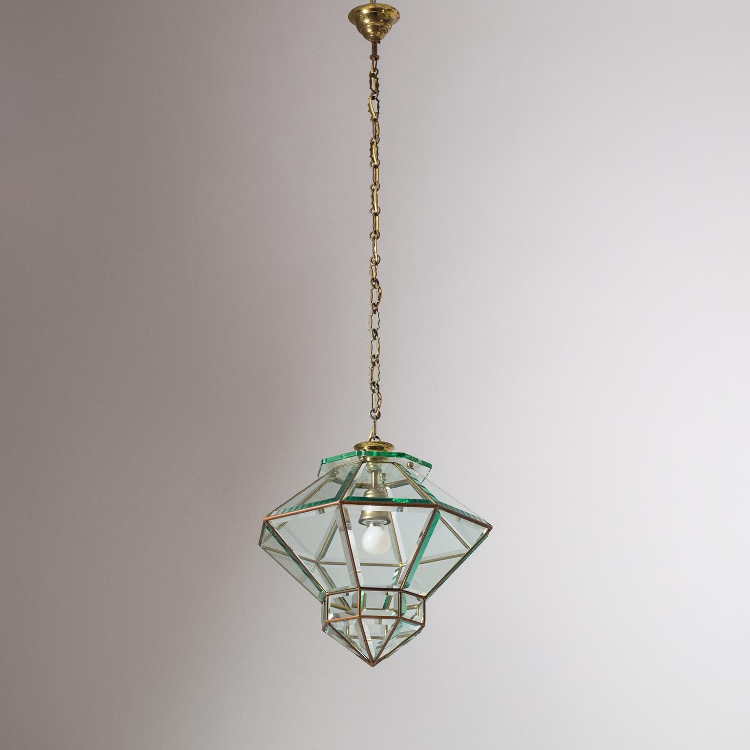 Fine Italian lantern with faceted glass from the 1940s. Unique octagonal gemstone cut shape with thick faceted glass elements inserted into a brass frame. Nice original condition with a light patina on the brass, heavy patina on the original iron