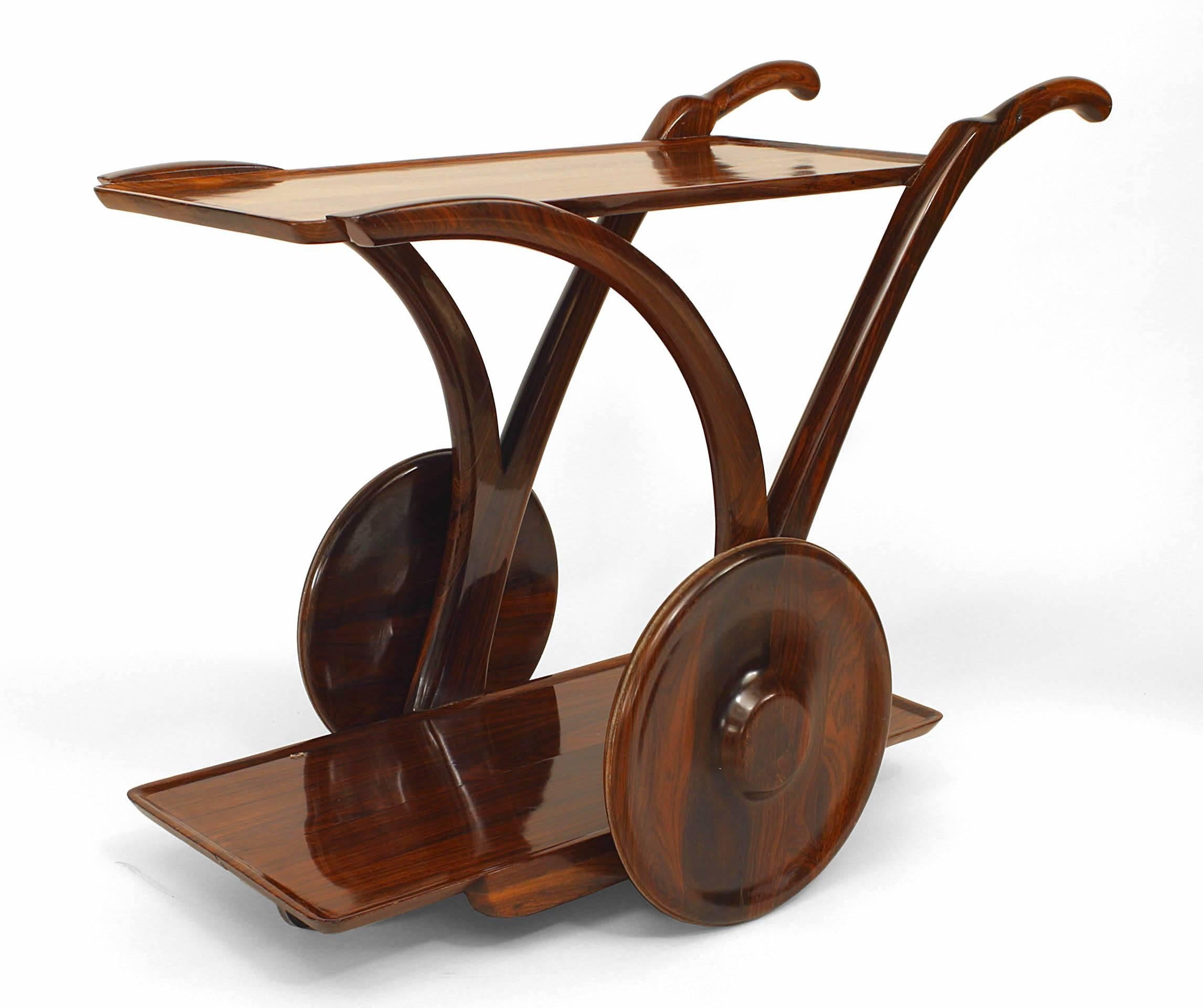 The unusual bar cart made of solid rose wood with shelf and 2 large centered wheels with front handles