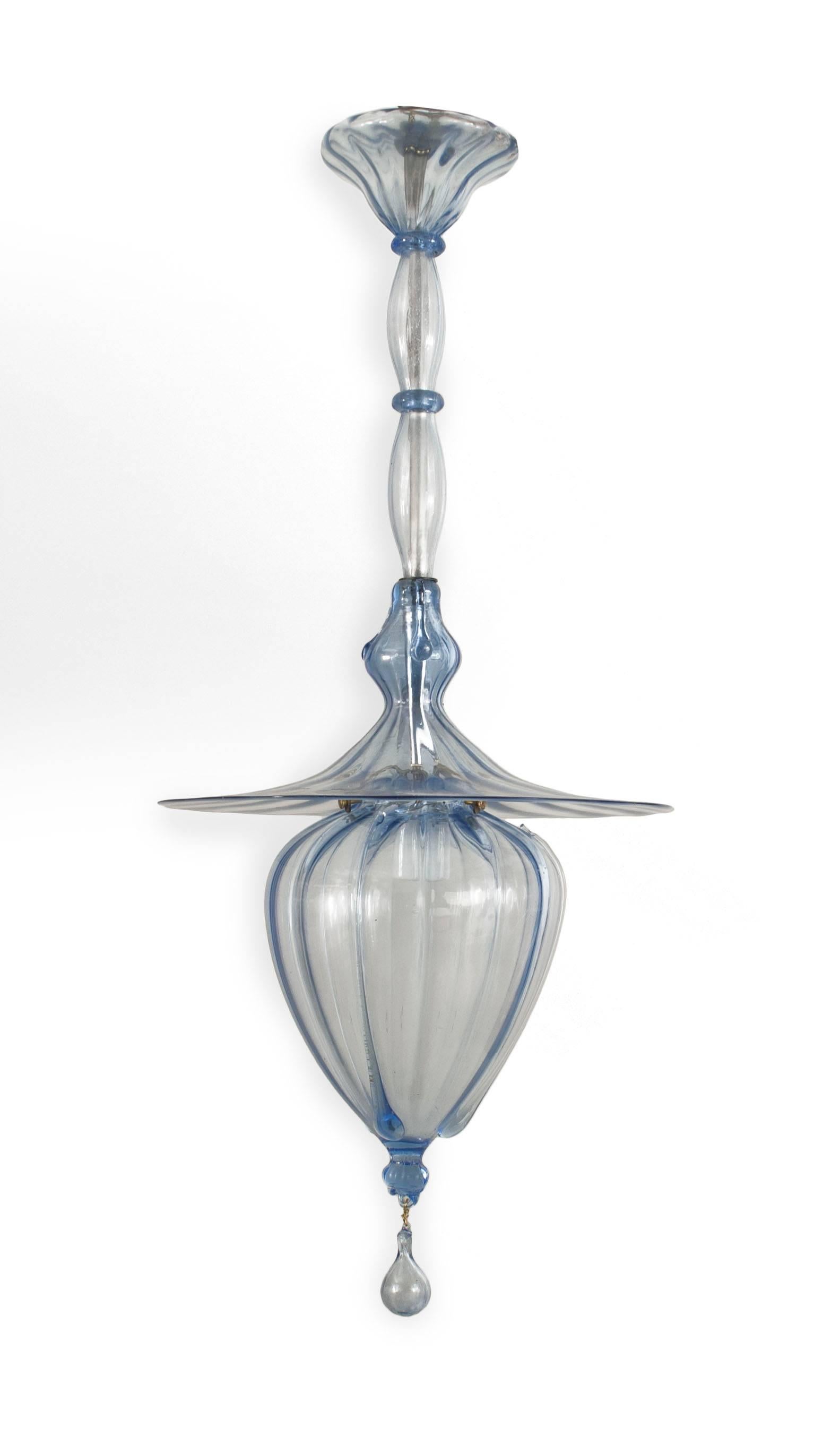 Italian 1940s tinted blue glass bulbous form fluted lantern under a large round glass shade and suspended from a tiered shaft with a finial bottom (by Venini).

 