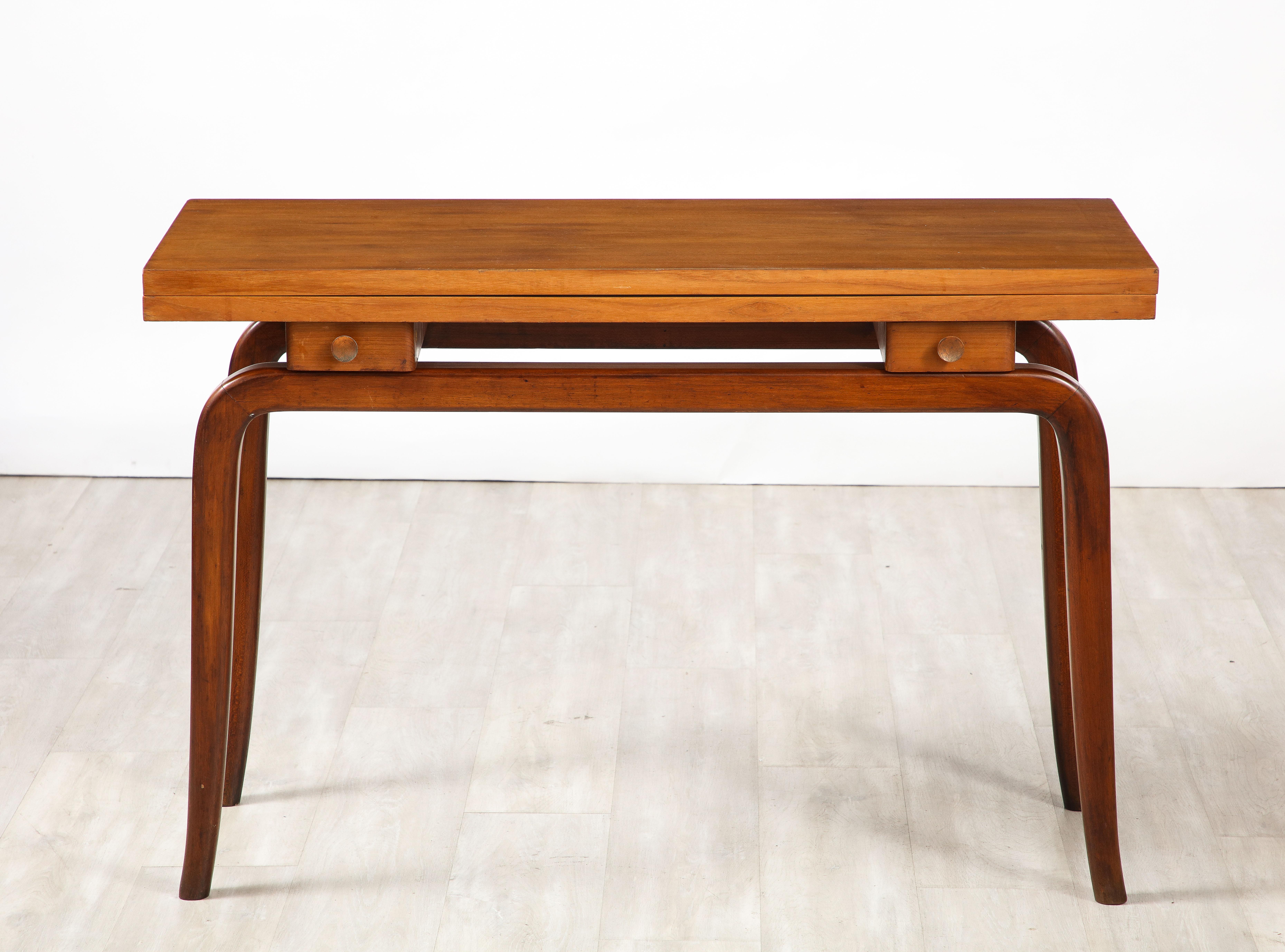 An Italian 1940's folding or flip-top walnut writing desk or console with two faux drawers, the top opens up to a larger surface with a warm beautifully faded pink laminate; highly practical to work on or eat from.  The rectangular walnut top
