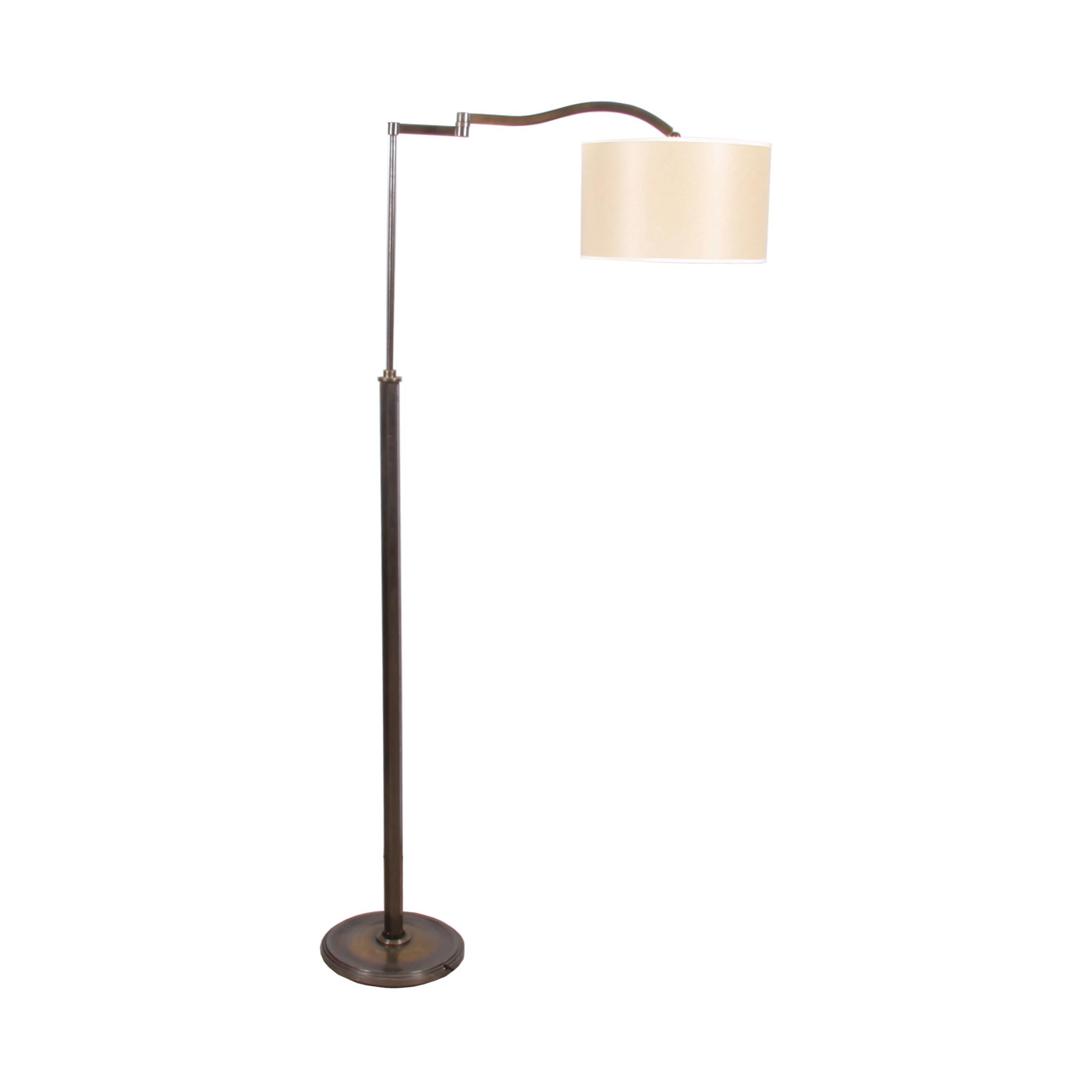 This Italian swing arm floor lamp is fully adjustable, as demonstrated by the pictures. An interesting design with a hexagonal column and a circular base. Made from patinated brass in the 1950s. A great addition to any room, these lamps are