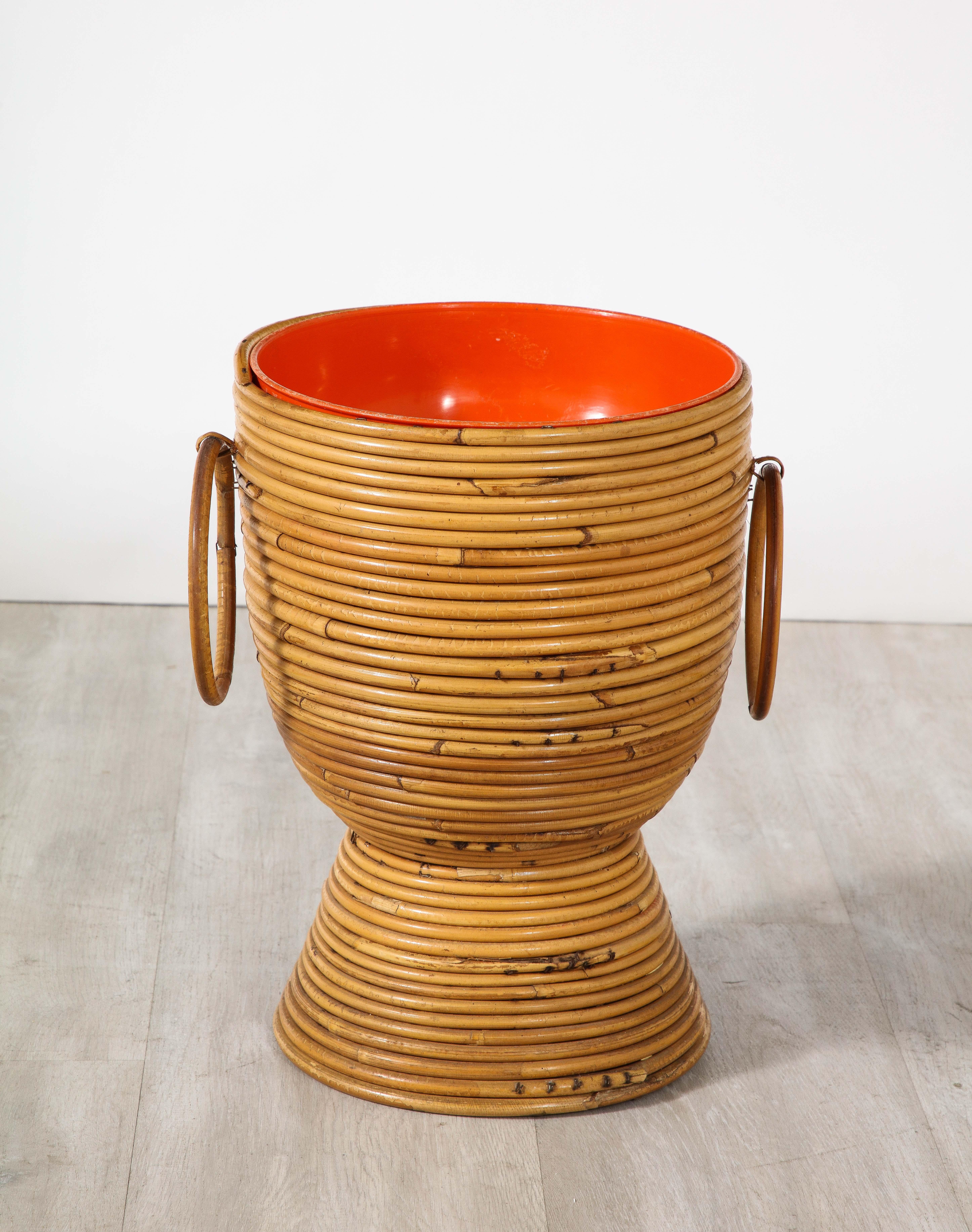 Italian 1950's bamboo ice bucket/wine holder with decorative ring handles and inset orange/red plastic liner. 
Can be used as a planter, flower basket, vase or decorative bowl. Whimsical, earthy and charming. 
Italy, circa 1950 
Size: 14