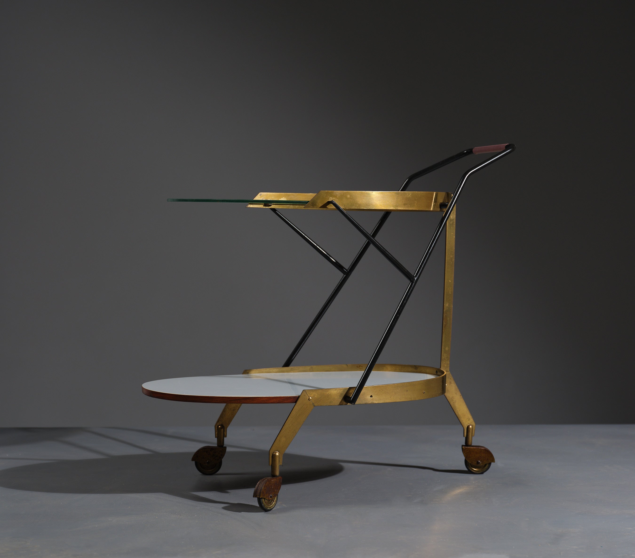 Presenting our exquisite Italian bar cart, a true embodiment of 1950s design. This elegant and functional piece serves as a bar cart, serving trolley, and liquor cart all in one. Its sleek and modern design, combined with Italian craftsmanship,