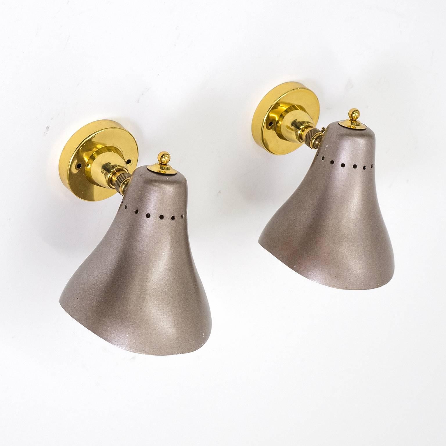 Charming pair of authentic Italian mid-century sconces. The curved aluminium cones are lacquered in an unusual metallic aubergine colour. Nice vintage condition with some minor loss of paint. Each sconce has one original brass and ceramic E27 socket