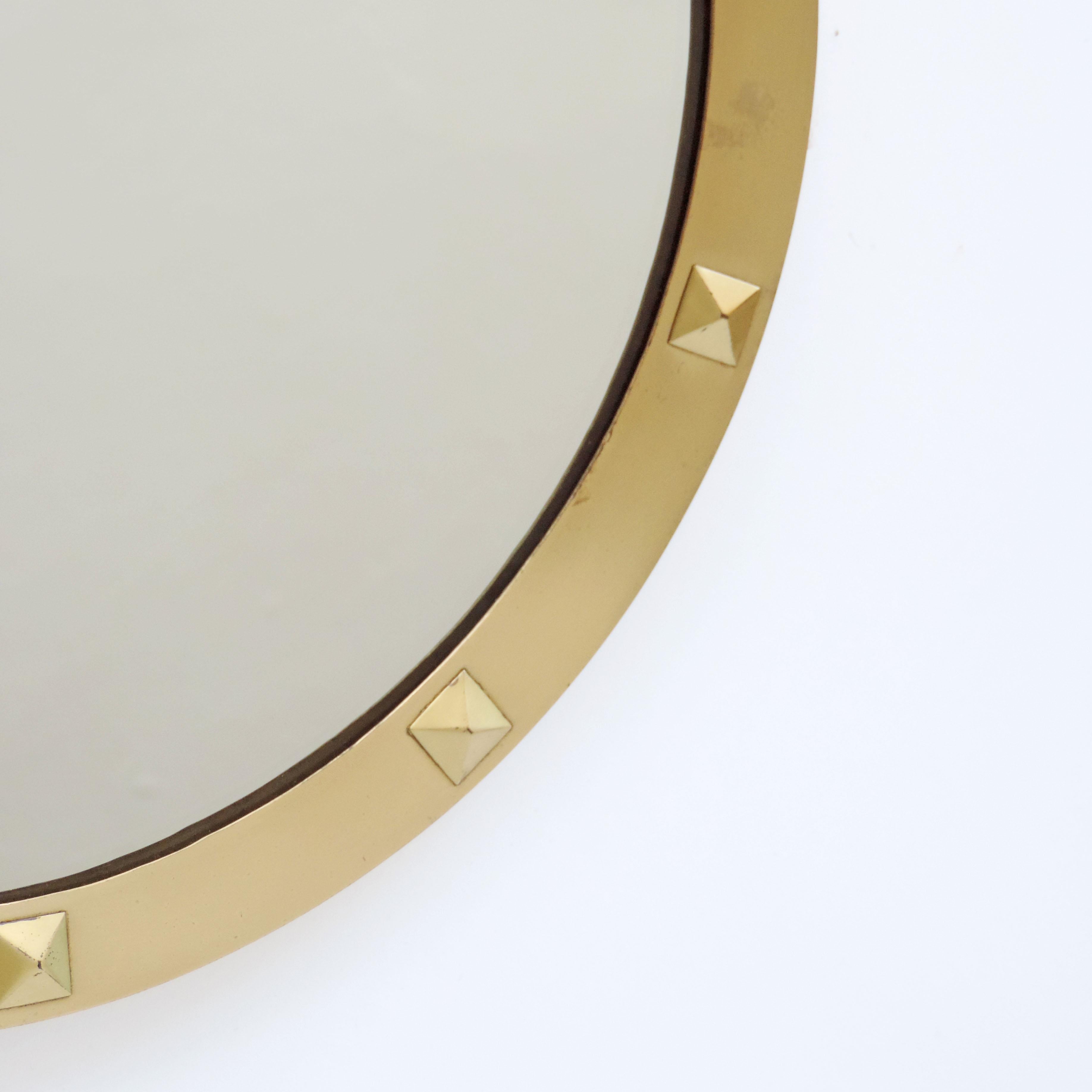 Italian 1950s brass and studs circular wall mirror.