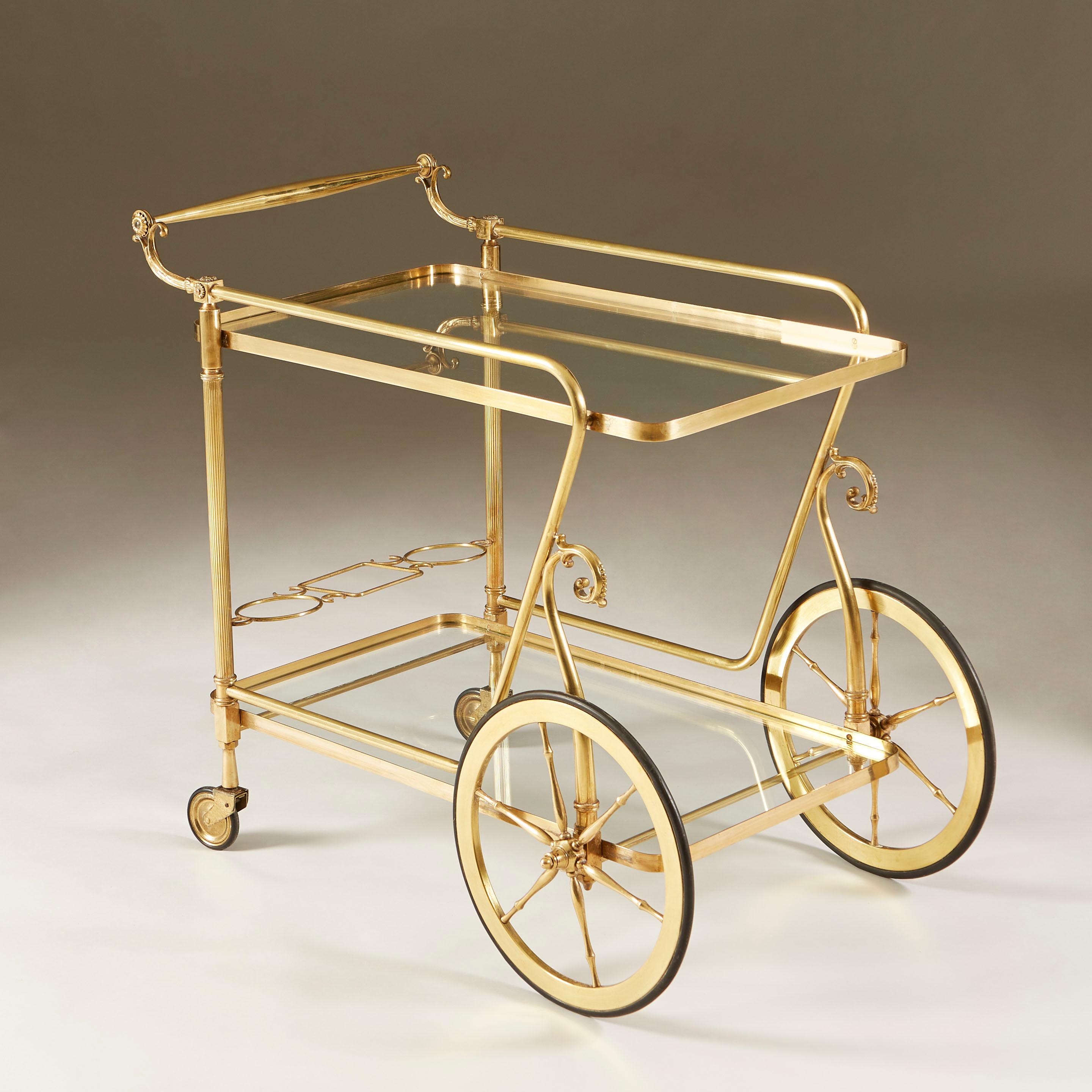 Classic Italian decorative brass drinks trolley with oversized front wheels, two glass shelves and brass holders to store three bottles. Excellent condition.