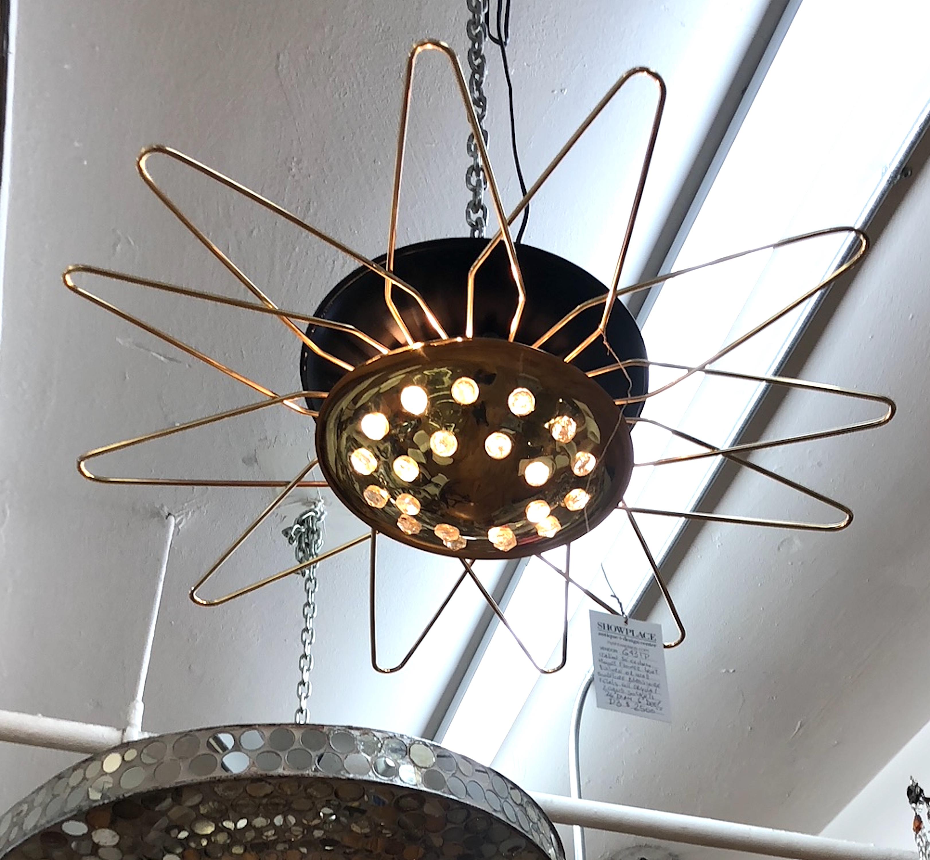 A sculptural Italian 1950s flush mount atomic style light. The fixture is a ceiling mount for overhead light or a wall mount for an illuminated sculpture or sconces. The back dish is black enamel with polished brass wire petals. The bottom dish is