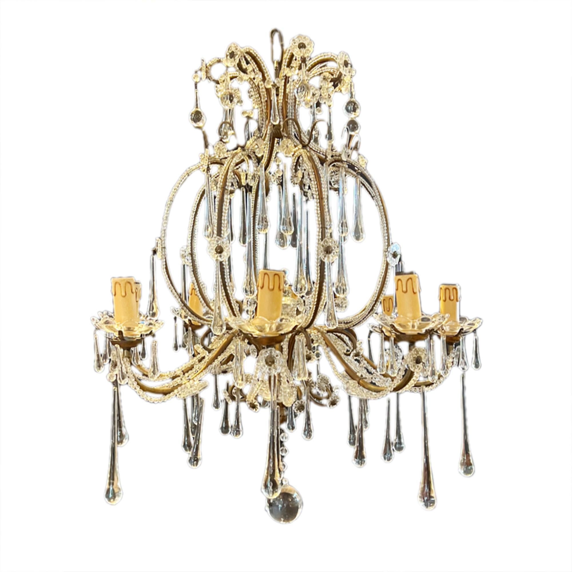This pretty, medium sized chandelier was made in Italy in the 1950s.

Very decorative - featuring tear shaped drops. These are smaller at the top and increase in size to much larger ones at the bottom. Glass flowers and the ball at the base finish