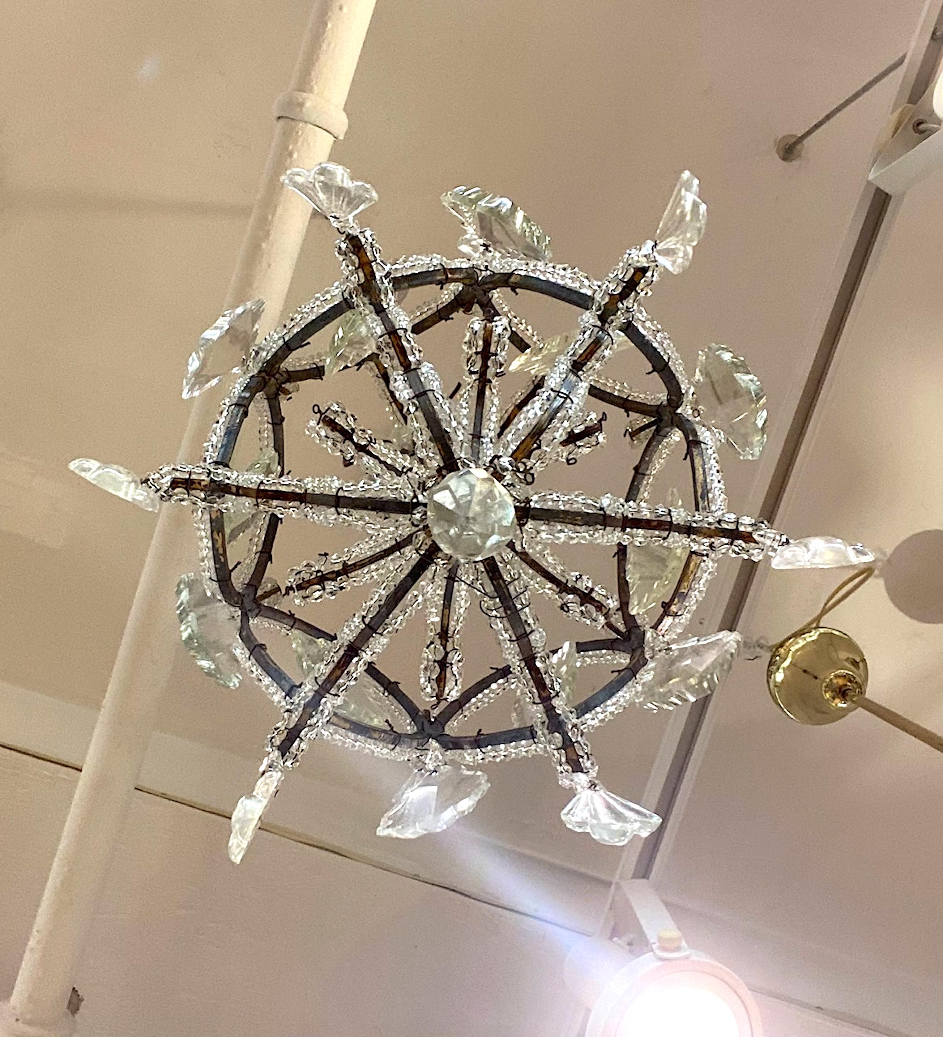 A lovely 1950s Italian pendant light perfect for an entry, powder room, hallway or walk in closet. The frame is iron with distressed gold finish and wired with faceted crystal beads. Additionally there are cut crystal pendants and prism hanging for
