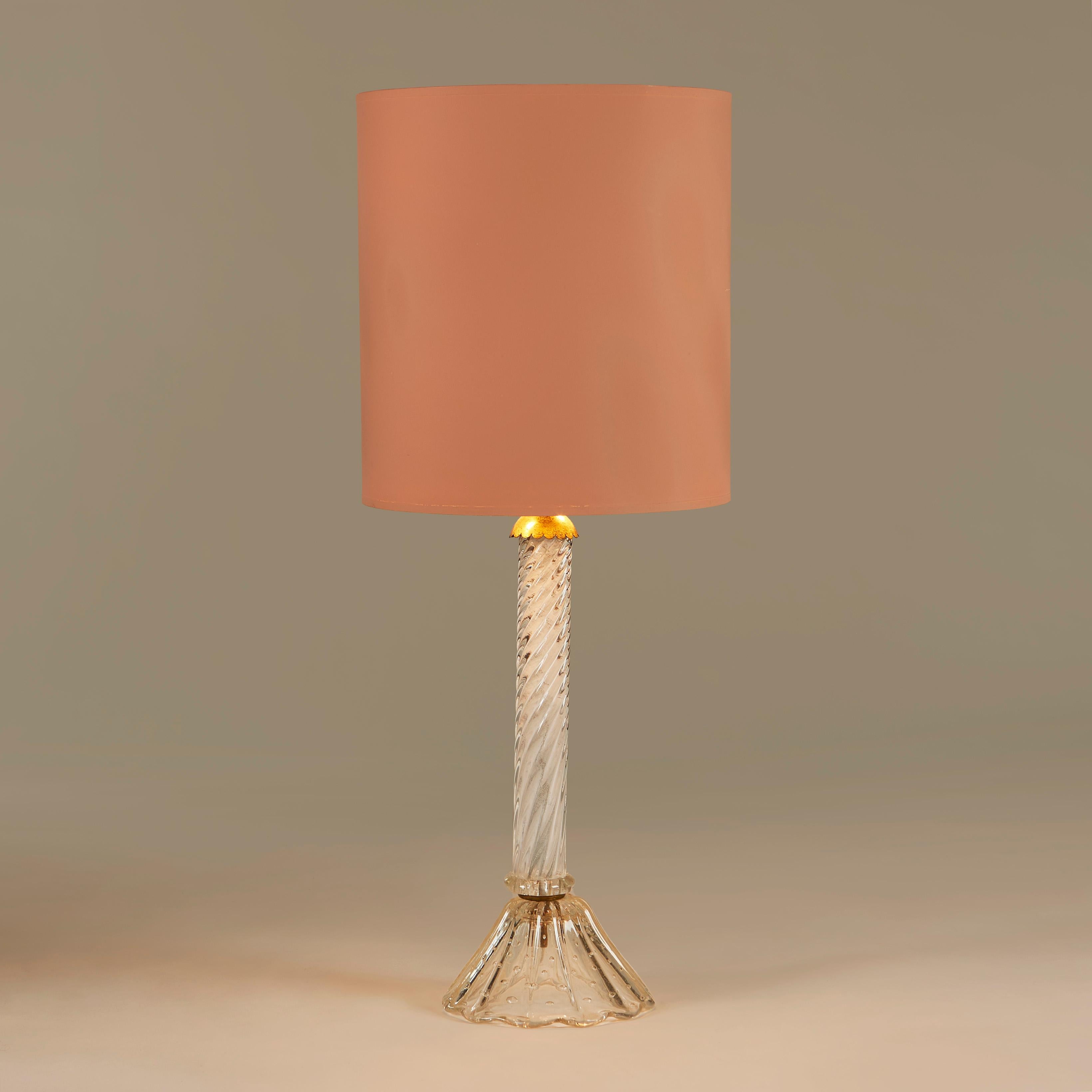 Ornate table lamp with twisted glass stem and fluted Bullicante glass base. Brass detailing around the bulb fittings.

58cm high x 16cm base diameter (69cm high x 28cm diameter with shade)

Lampshade is complimentary - it does have a small
