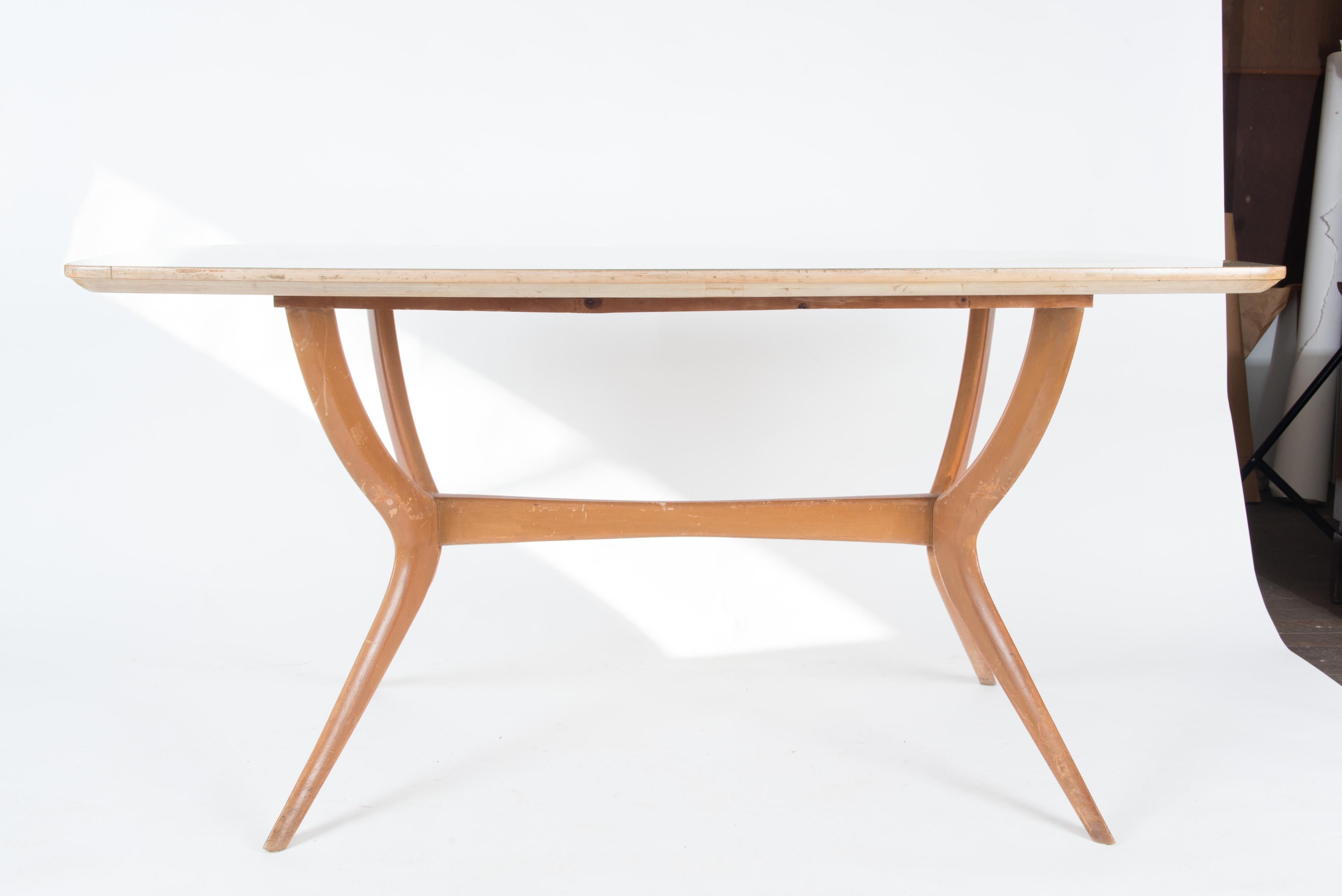 Sleek light wood 1950s dining table or desk. The wood top is hand painted under glass.