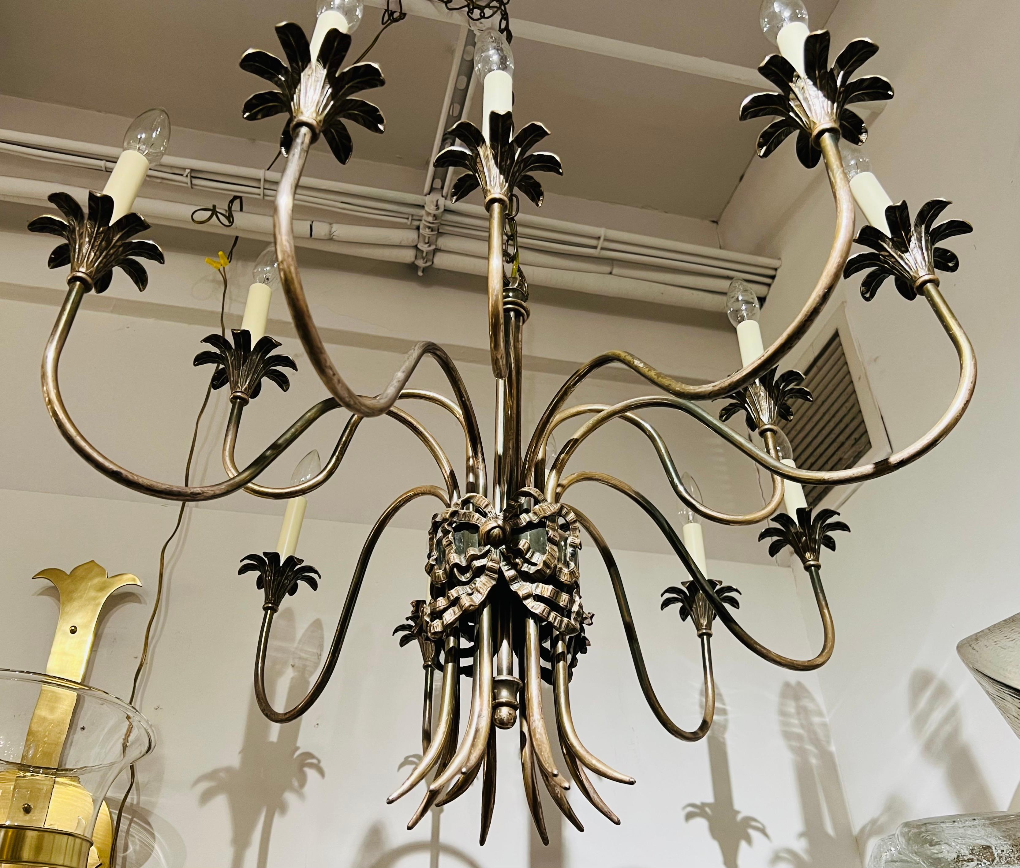 A wonderful Empire style Italian chandelier in the style of Buccellati. Rewired. 12 Light sources. Candelabra sockets. Rewired. 23” is the body. The chain can be adjusted to your needs. Great decorative details.