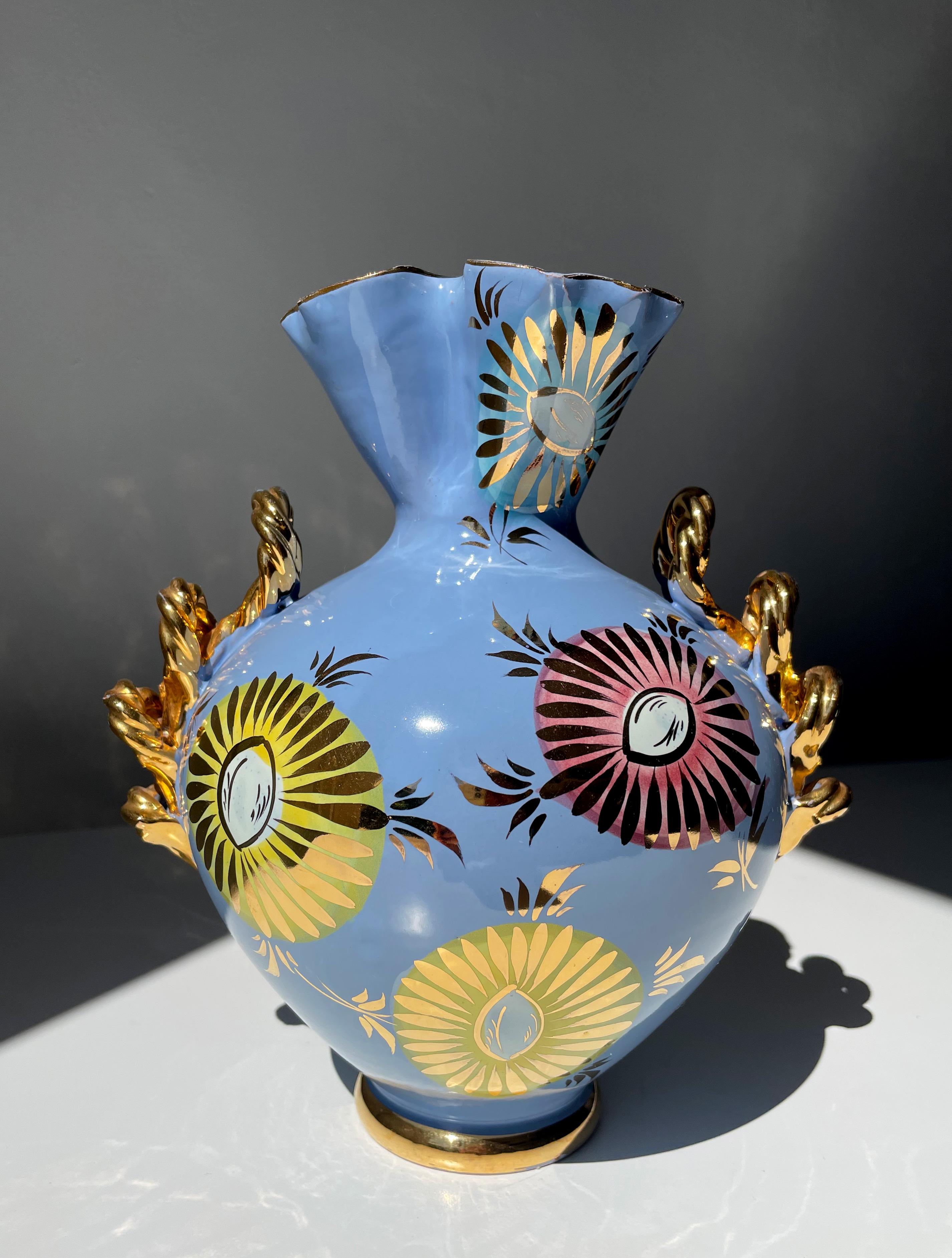 Organically shaped Italian midcentury porcelain vase manufactured by Studio Fiamma, Sesto Fiorentino in the 1950s. Glazed in a shiny light sky blue color and decorated by hand with large pastel colored flowers in yellow, rose and blue with golden