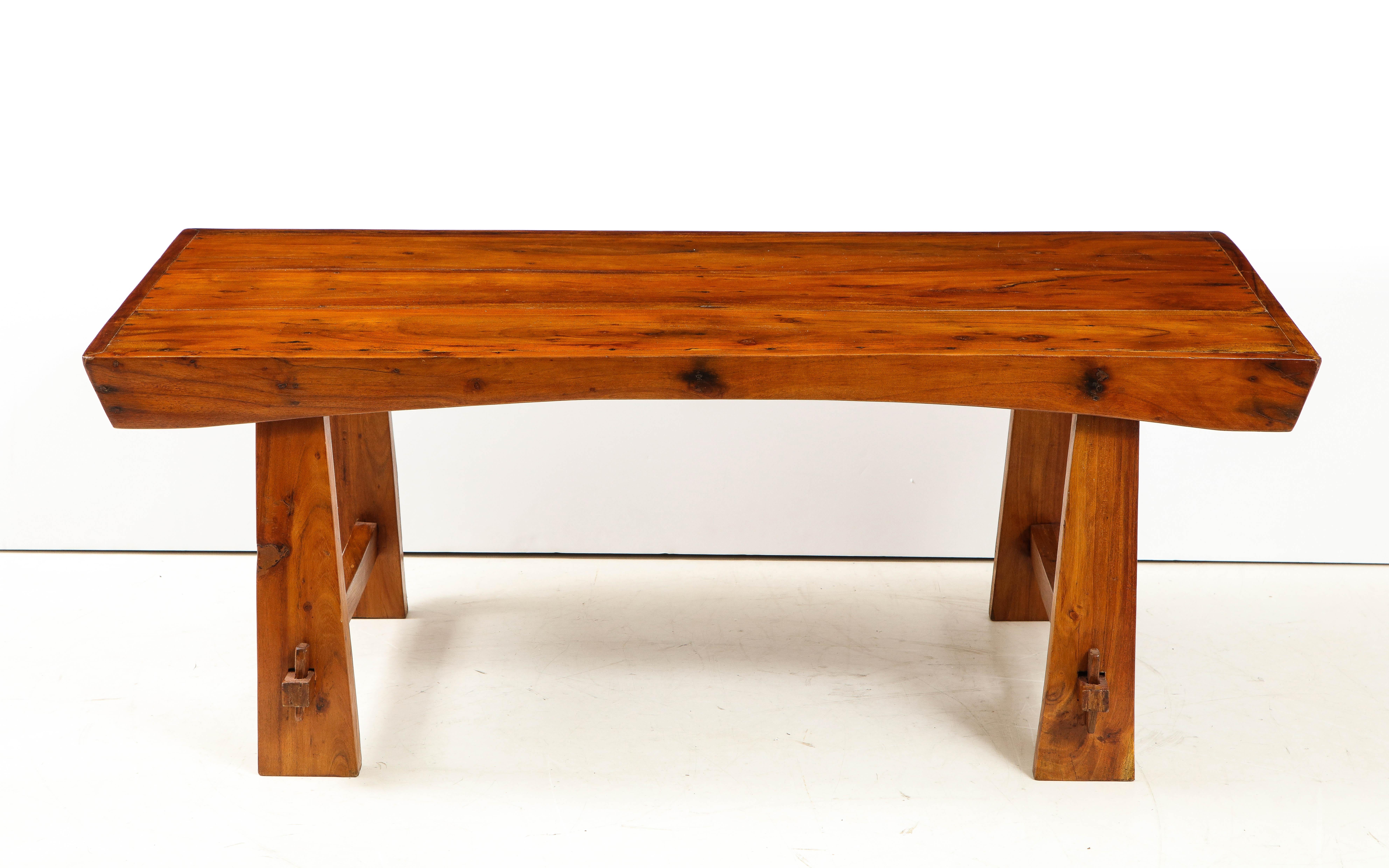 An Italian 1950s Folk Art solid walnut coffee table; grand in size and scale; this rustic piece evokes a Wabi-sabi organic modern feel for a chalet or condo in the sky. Artisan piece from Italy.
Size: 20