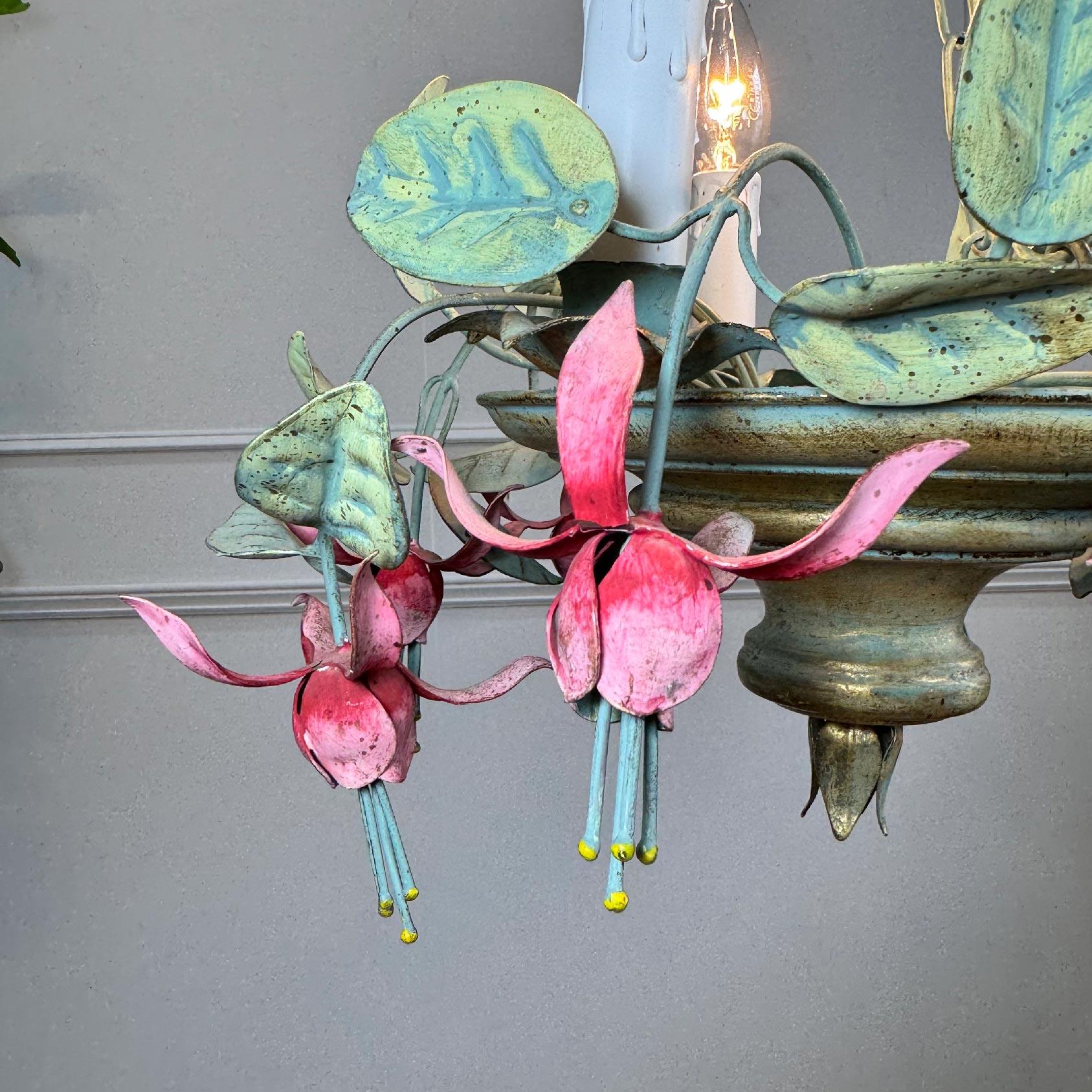 A beautiful and incredibly rare 1950's Italian hand painted chandelier, in the form of Fuchsia Flowers and foliage. In bright pinks, and natural green tones.
The light has 3 single e14 (small screw in) lamp holders.

Height 64cm (inc chain and rose)