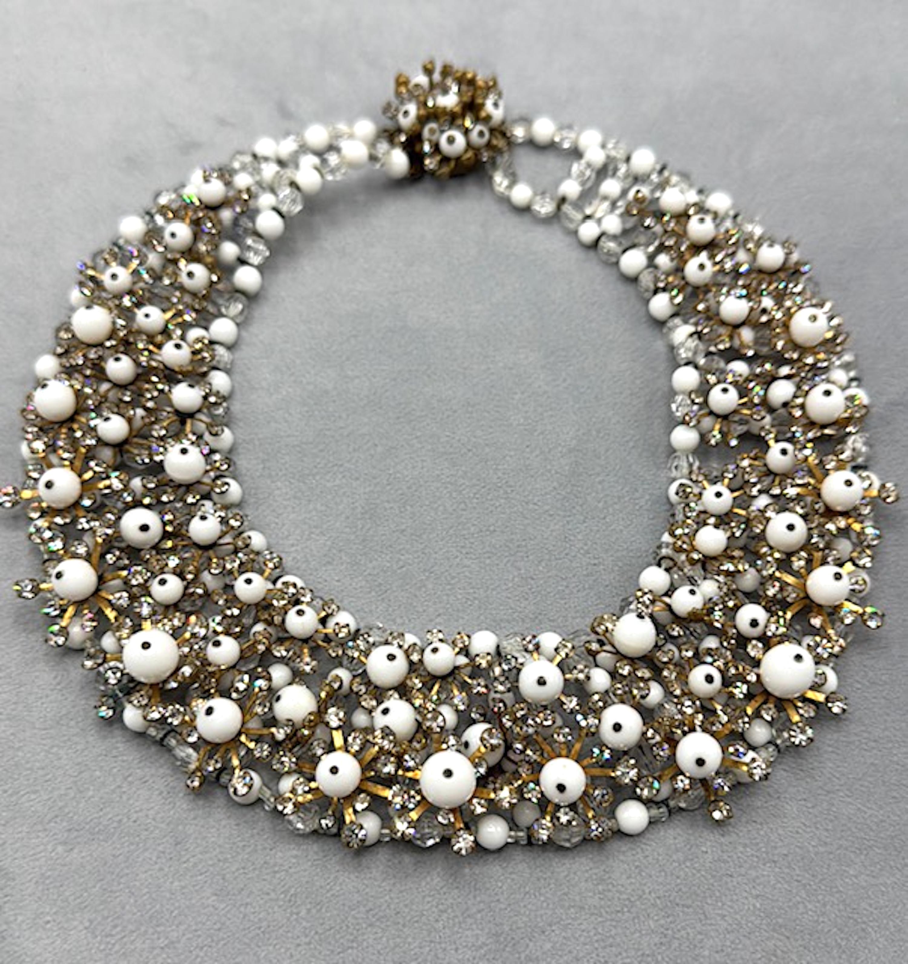 Presented is a magnificent example of an Italian 1950s fashion or costume necklace. The piece is hand made in a construction of clear crystal and white glass beads in large and small sizes strung together. Additionally, incorporated onto the