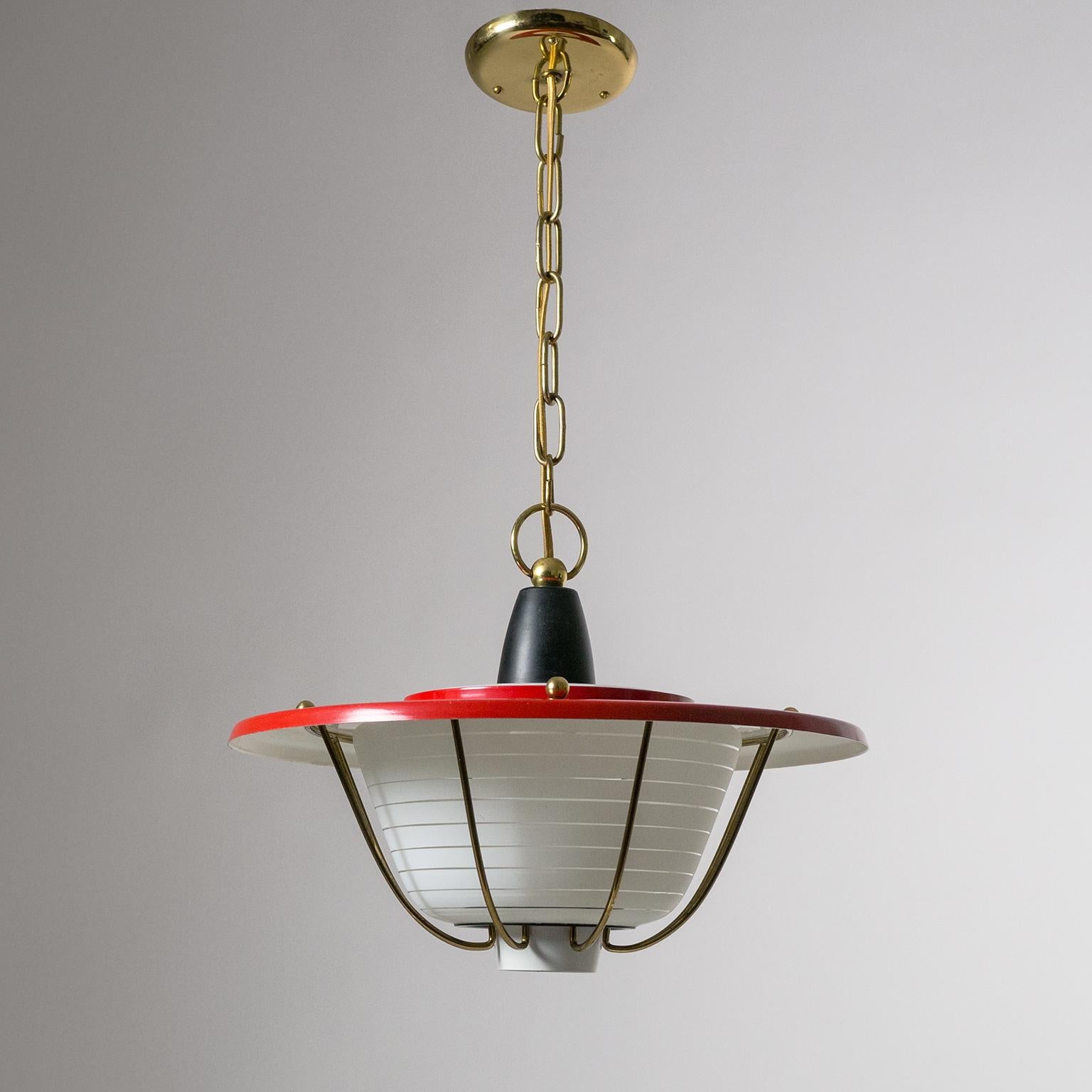 Charming French midcentury lantern with a striped glass diffuser, red lacquered shade and brass cage. Very good original condition with minimal wear to the lacquered parts and a light patina on the brass. One original brass E27 socket with new