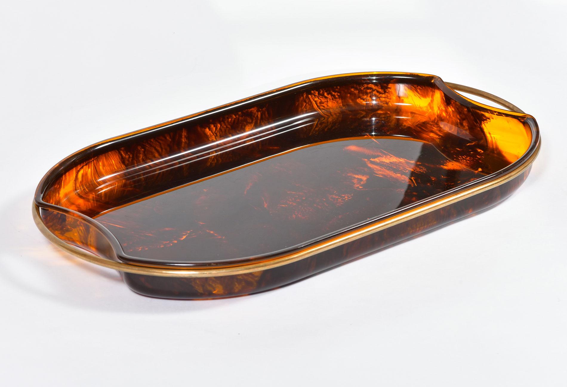 Substantial oval shaped faux tortoise shell tray with simple brass handles.