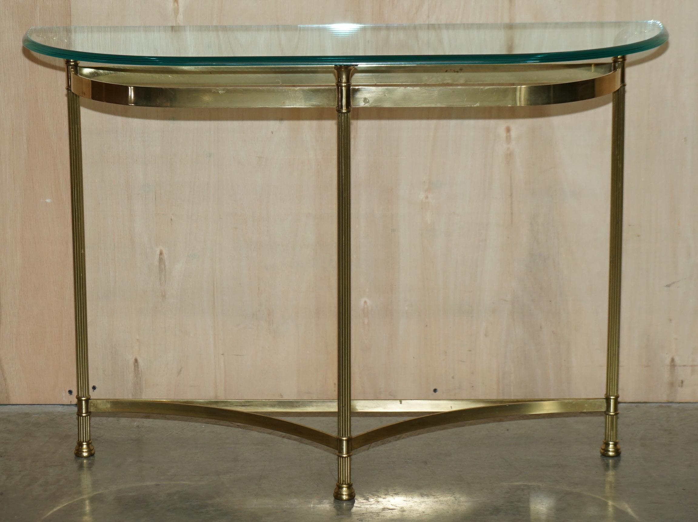 We are delighted to offer for sale this very fine, circa 1950’s Mid Century Modern brass and glass demi lune consoles table.

A good looking well made and decorative piece, the beauty of this piece is in the subtle detailing, it has wonderful