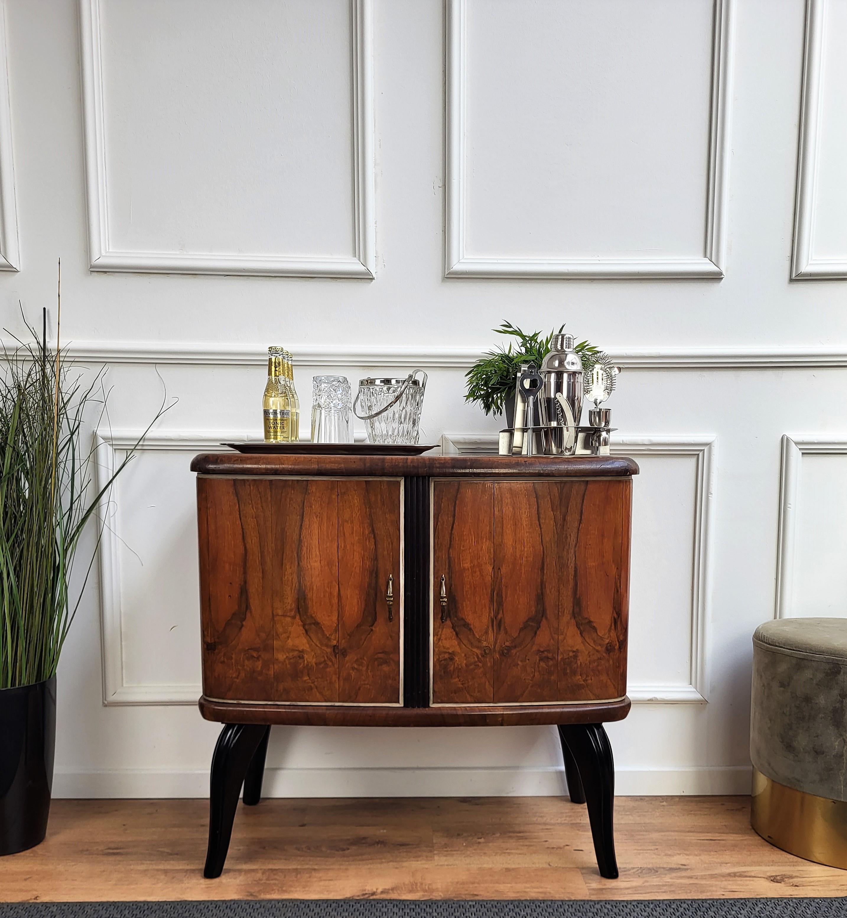 Very elegant Italian Mid-Century Modern drinks dry bar cabinet with beautiful veneer walnut briar burl wood, two doors and great central wooden decor craftmanship and brass handles. When opened, on the left side an amazing interior part in mirrors