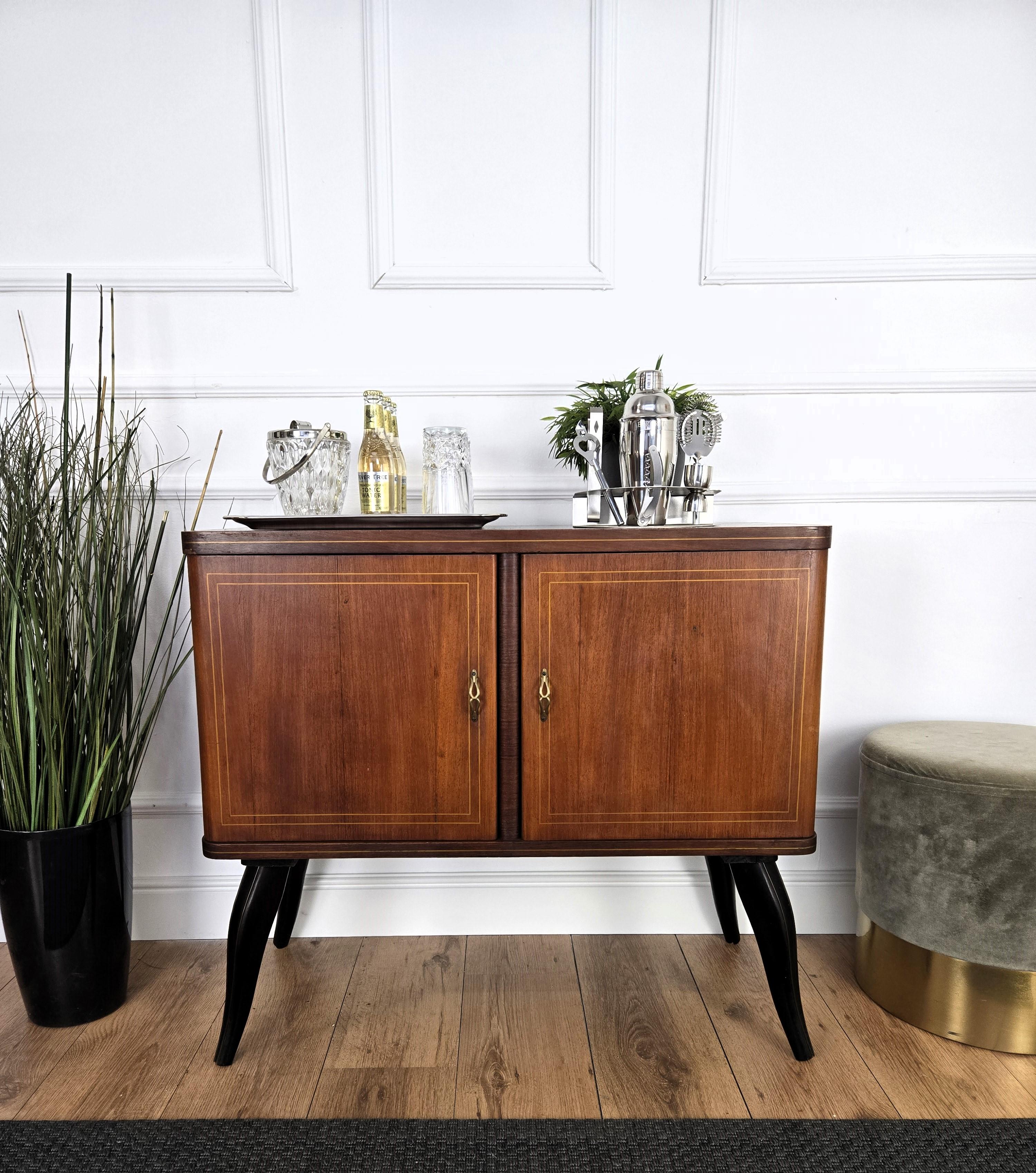 Very elegant Italian Mid-Century Modern drinks dry bar cabinet with beautiful wood, two doors and great brass linear decors and handles. When opened, on the right side an amazing interior part in mirrors mosaic and glass shelf ideal as server or
