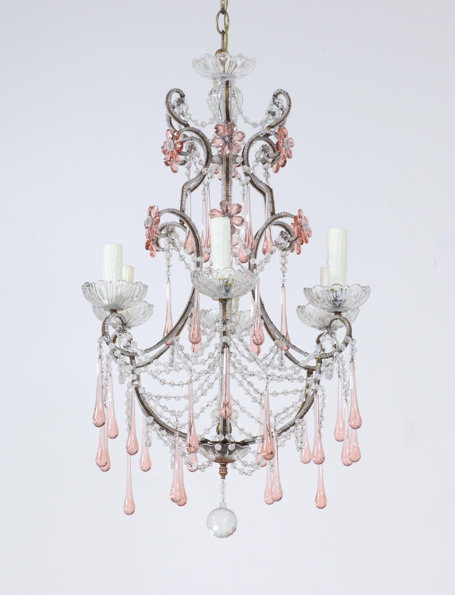 Very pretty, Italian 1950s gilt iron and crystal beaded chandelier.

The chandelier consists of a shapely crystal beaded, gilt-iron frame with pink glass flowers and drops.

The chandelier is wired and in working condition, it requires 6 candelabra