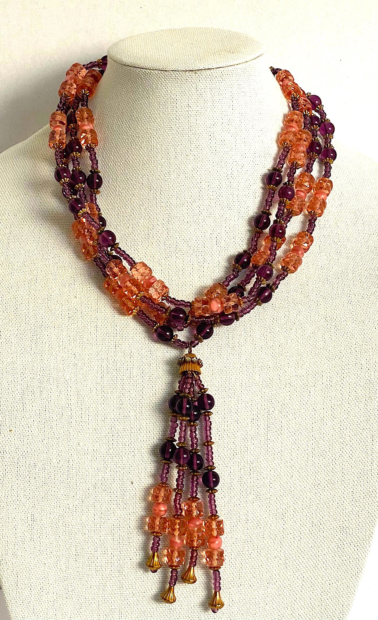 A lovely Italian four strand glass bead necklace from the 1950s. The purple beads are hand made polished amethyst color glass. They are interspersed with faceted pale pink crystal disk beads and satin finish givre' clear and pink round beads.