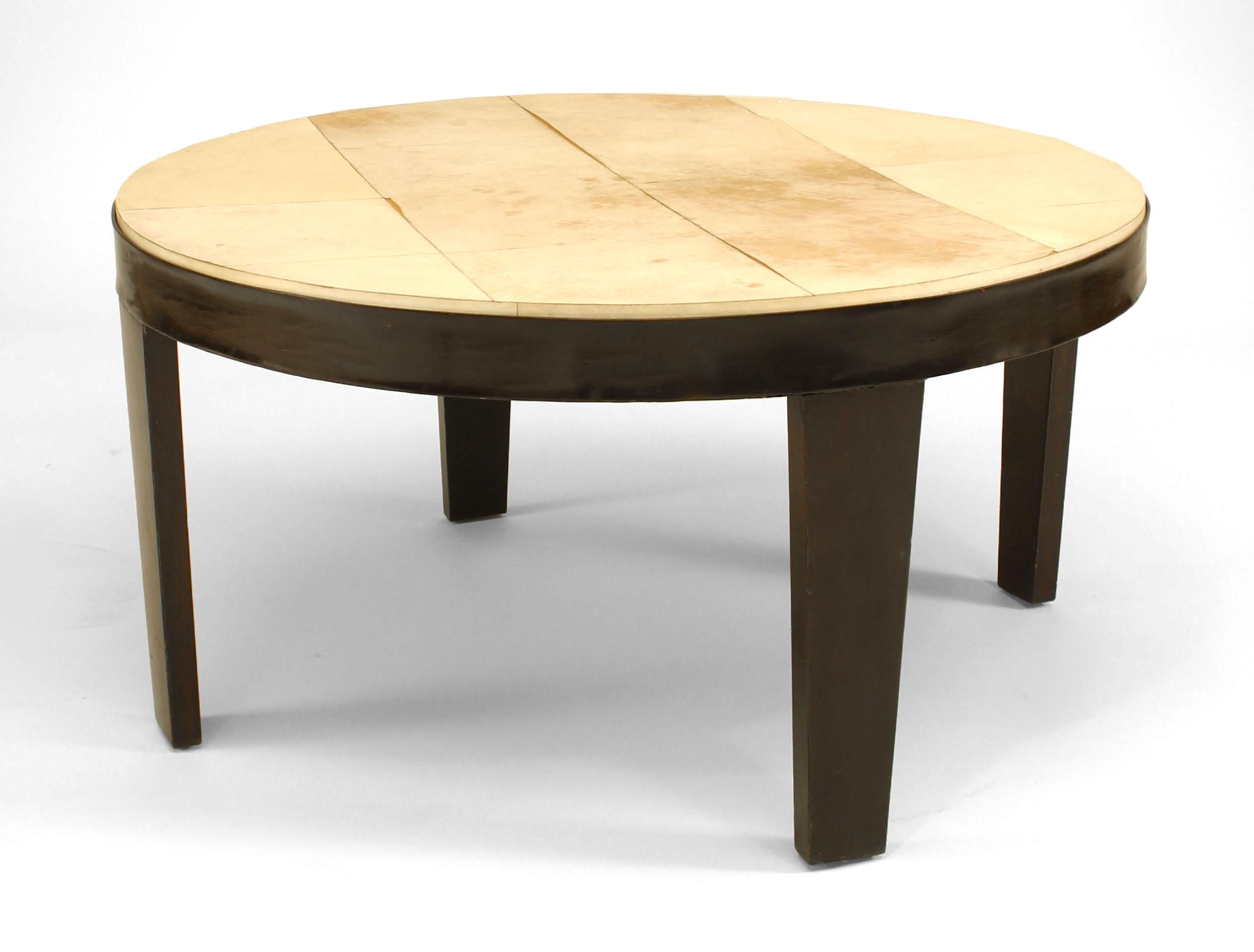Italian Mid-Century (1950s) round parchment top coffee table with four ebonized wooden legs.

Antique condition.  Parchment is peeling,
