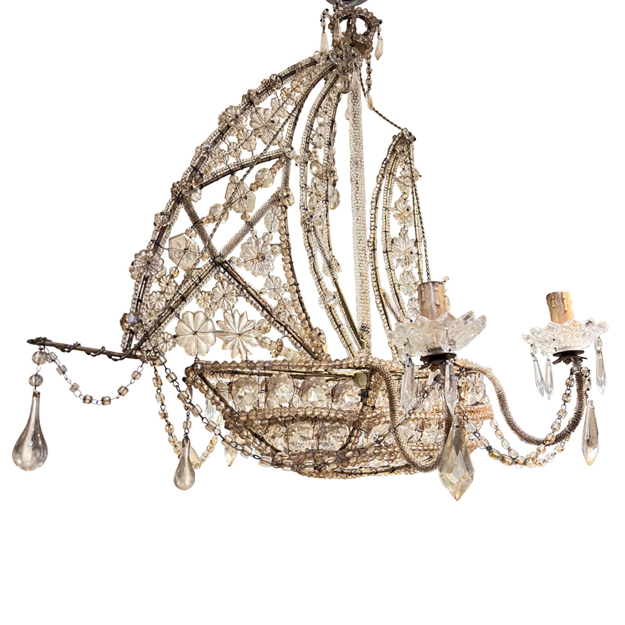 Ce lustre très décoratif a été fabriqué à la main en Italie dans les années 1950. La coque, le gréement et les voiles sont ornés de superbes perles, et un intéressant nid de pie est placé au sommet du mât, qui est recouvert de minuscules perles.