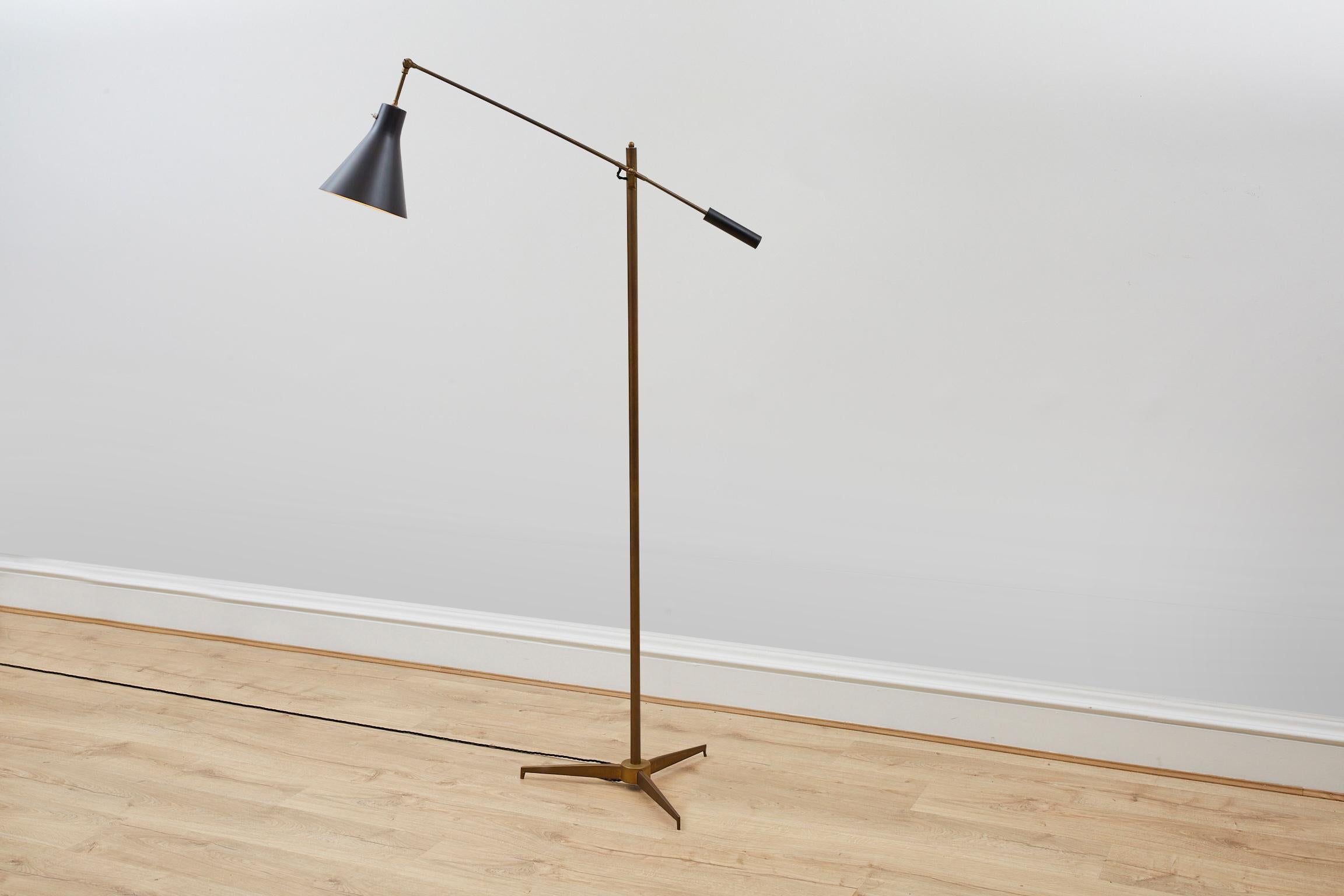 A super stylish Italian 1950's Floor Lamp by Arredoluce Monza. 

The Lamp features a slim brass pole set on a tri - legged brass base with black enamelled classic cone shaped shade.

The arm that holds the shade can be adjusted to change