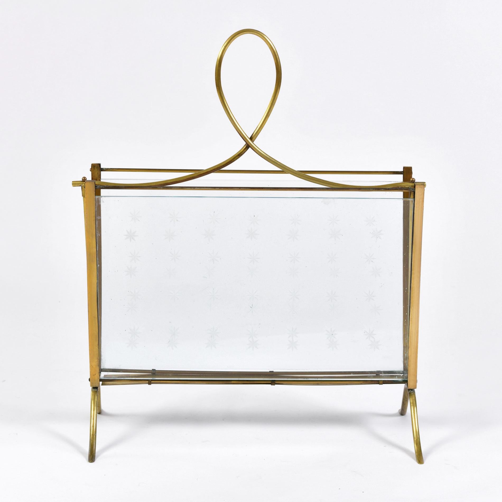 Decorative brass and glass magazine rack with etched 'star' pattern. Curved brass handle and feet.