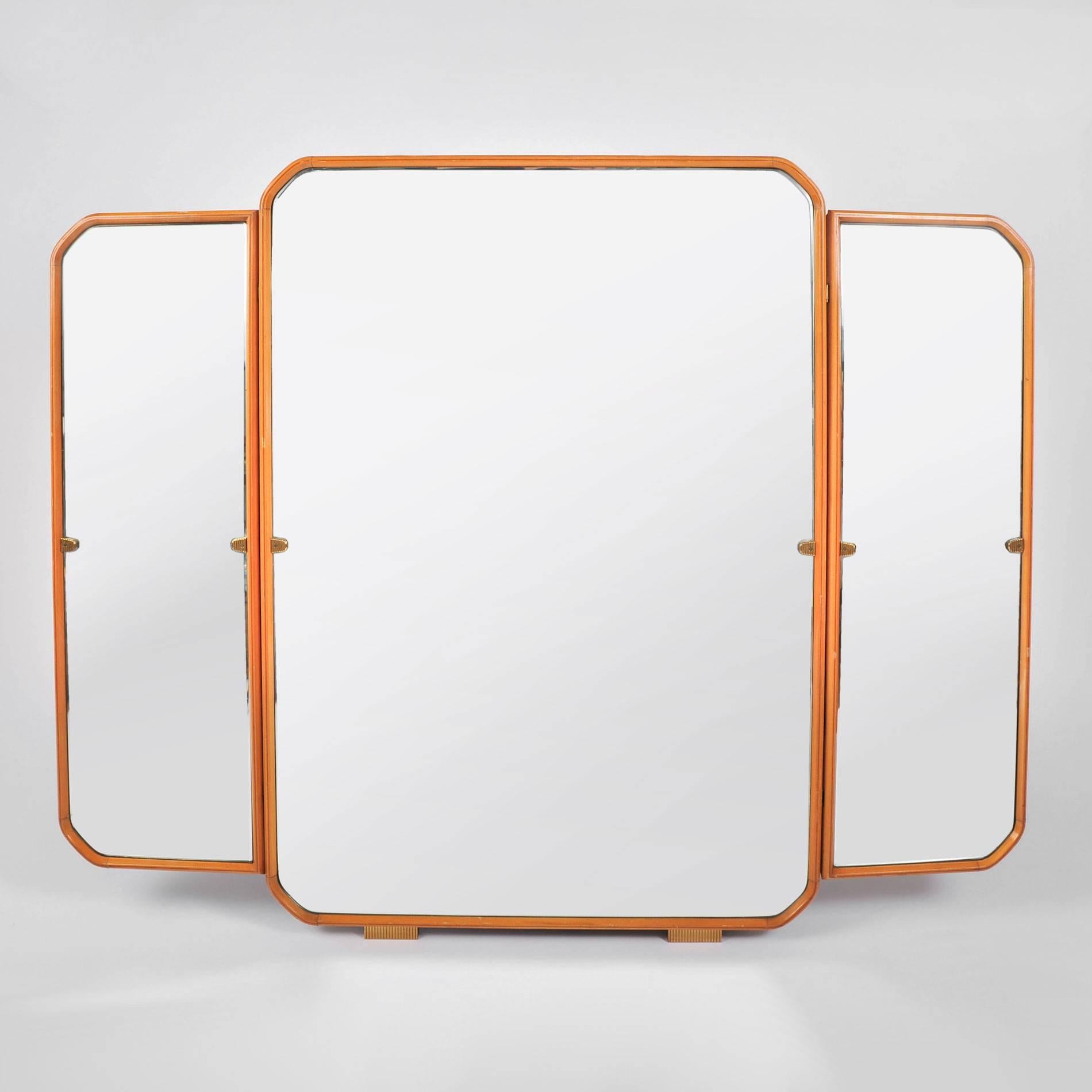 Substantial triptych wall hanging mirror. Pale fruitwood frame with curved corner detail. Decorative brass hinges and feet.
The measurements below are for the whole mirror including the side panels – the central panel is 29.25 inches wide.