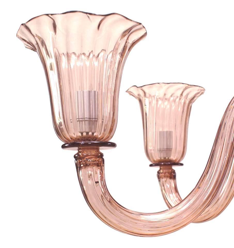 Two Italian 1950s Venetian Murano amethyst colored fluted glass six-arm chandelier with flaired design cup shades and shaped stem with finial drop at bottom (priced each).
     