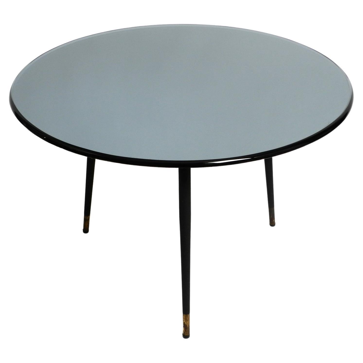 Italian 1960s blue gray round mirrored glass side table with metal tripod base For Sale