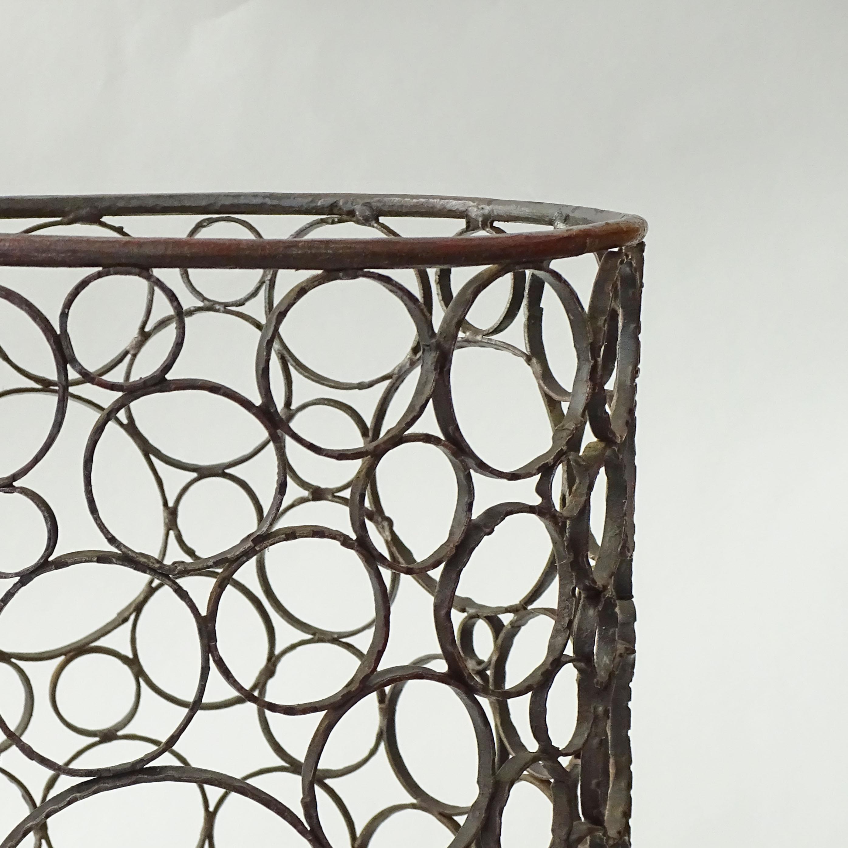 Splendid Italian 1960s Brutalist Wrought Iron and Copper Umbrella Stand.
Different-sized circles in metal scraps are attached to form an Umbrella Stand with a base and copper water drop collector.