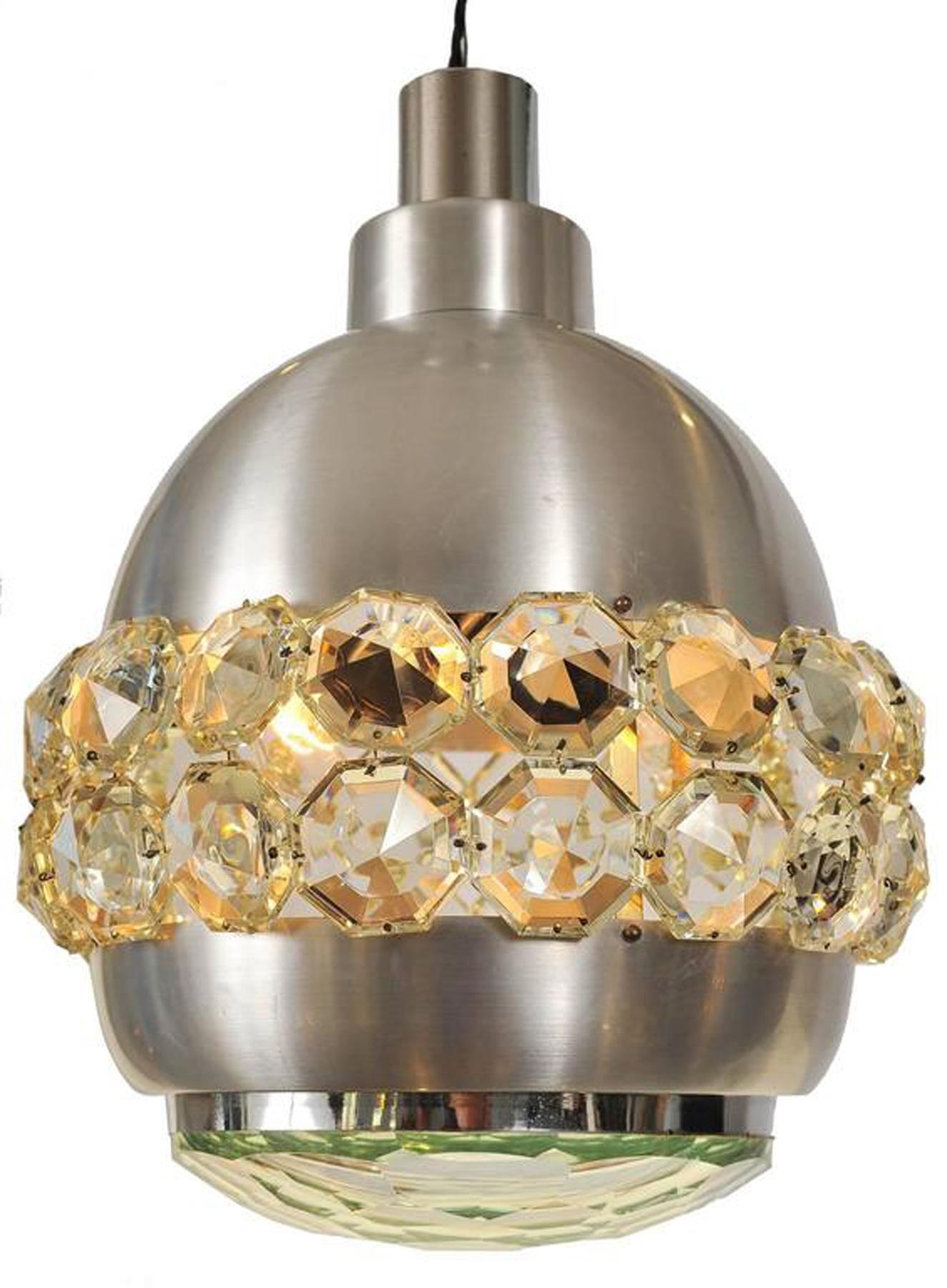 Glamorous chrome chandelier with decorative ring of faceted glass, exuding sparkly light. Shaped glass base. 

 