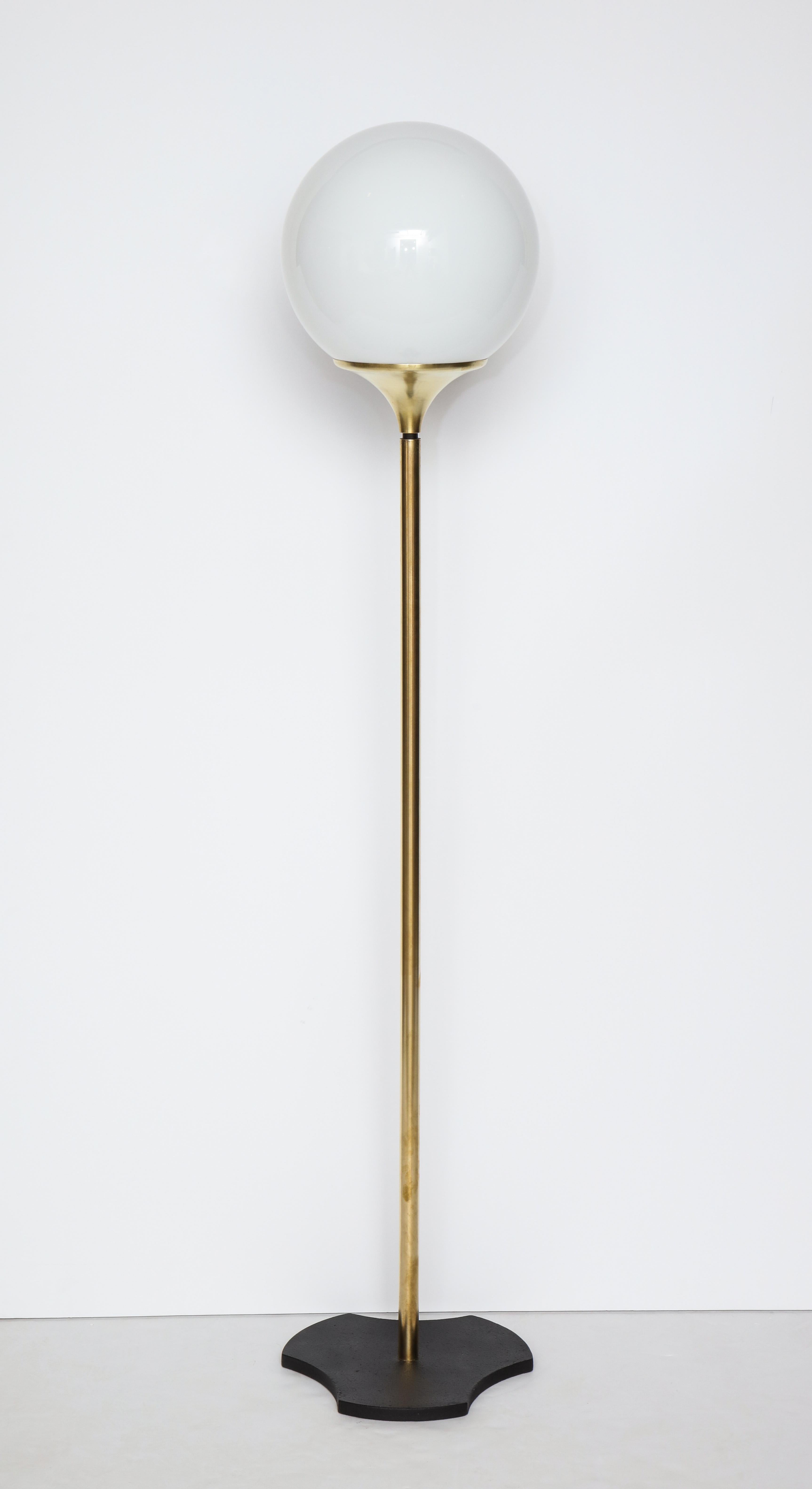 Italian 1960s floor lamp with opaque glass globe fixture; supported on a tripartite black stone base.
Italy, circa 1960.
Size: Total height 59 1/2