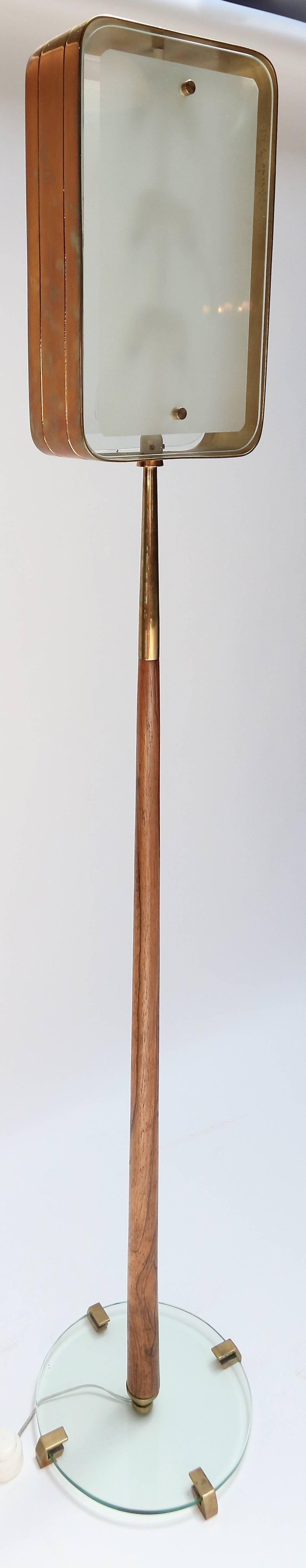 Floor lamp from the 1960s in the style of Fontana Arte with brass frame surrounding frosted glass and a wood and glass base. Lamp has six-light bulbs.