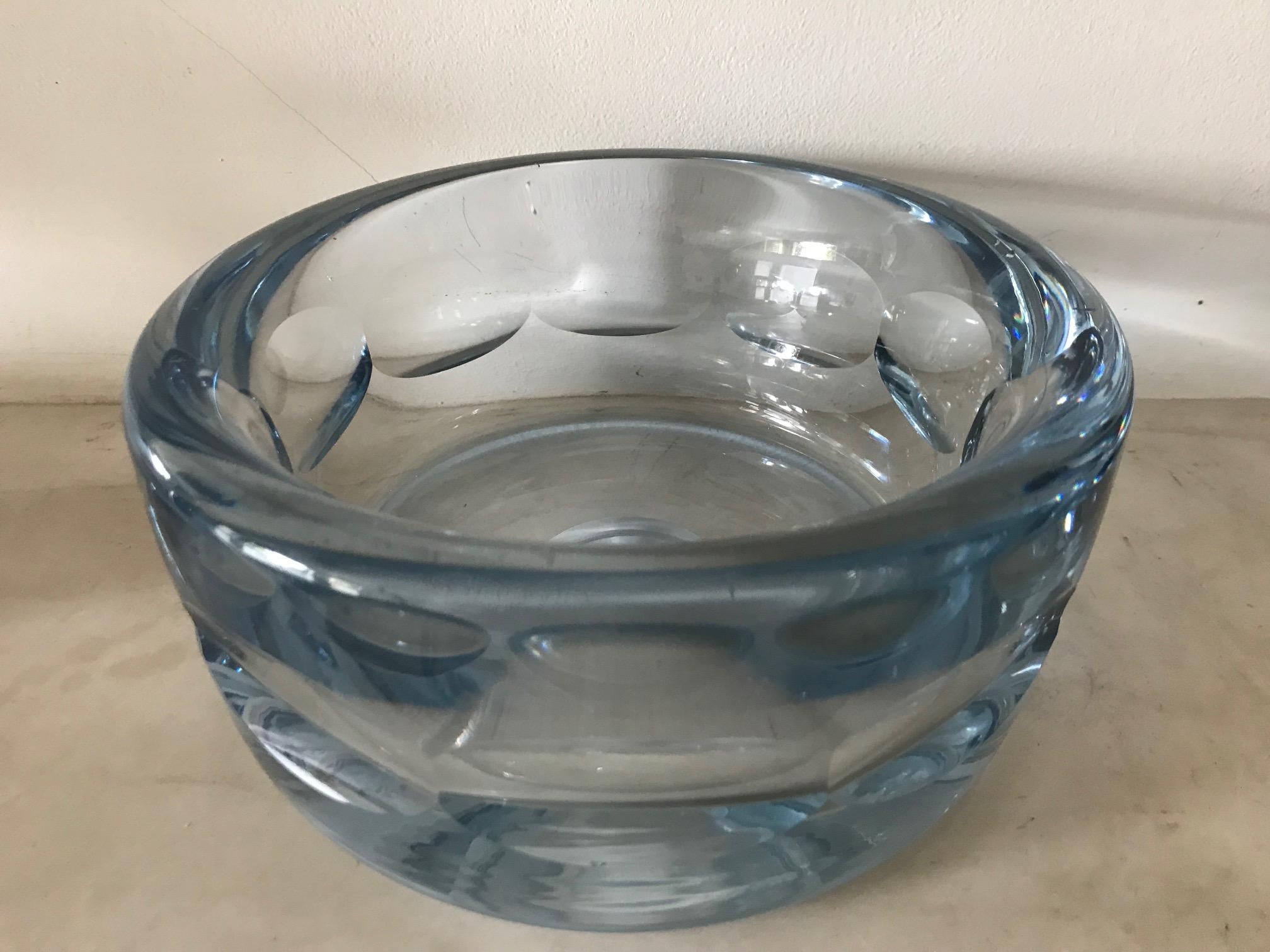 A fabulous handblown and with oval cut out detail heavy clear light blue glass bowl or vide poche. Indistinctly signed on the base.