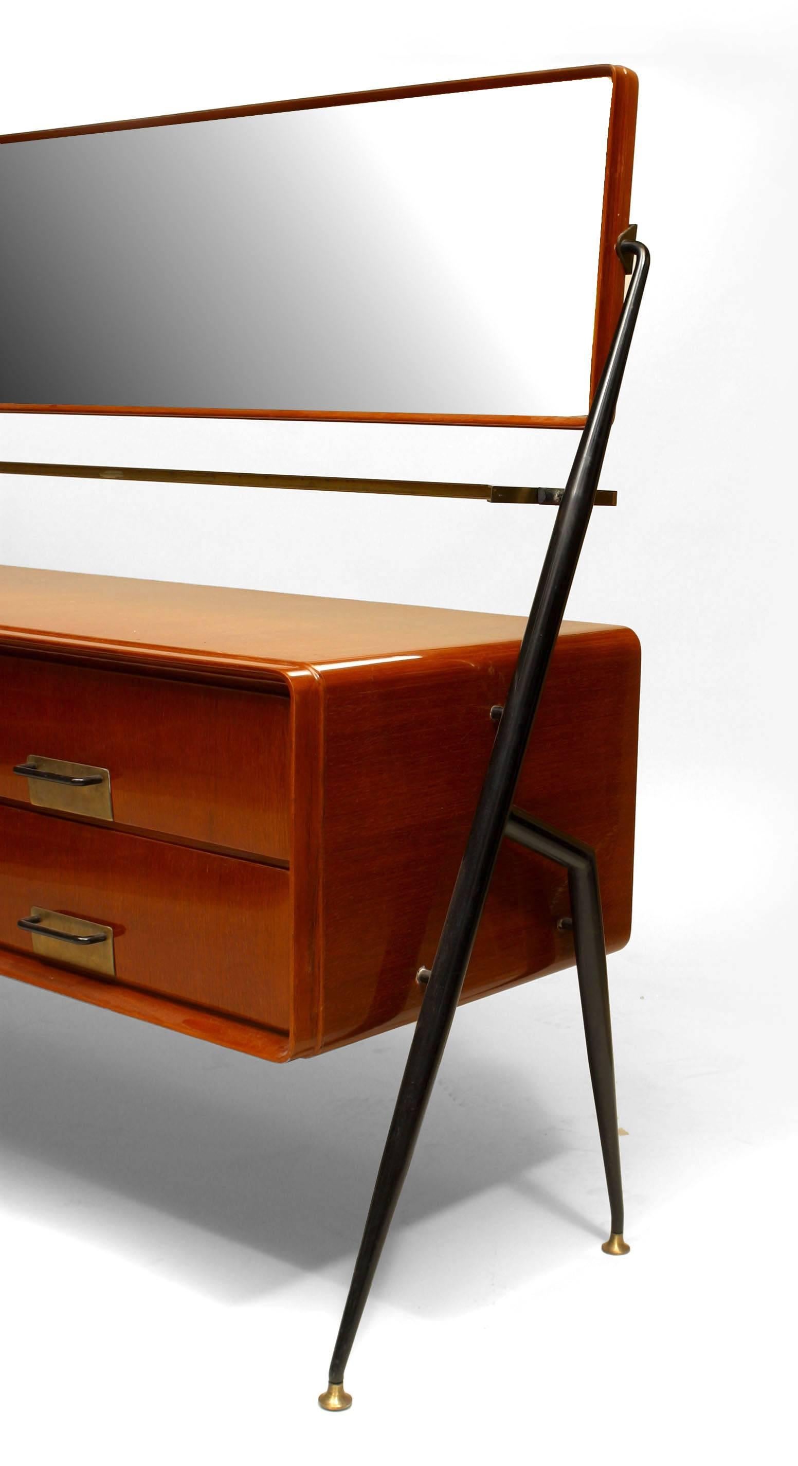 Italian 1960s mahogany chest with six drawers having a glass shelf under a swivel horizontal bevelled glass mirror supported by ebonized metal side supports (Silvio Cavatorta).
 