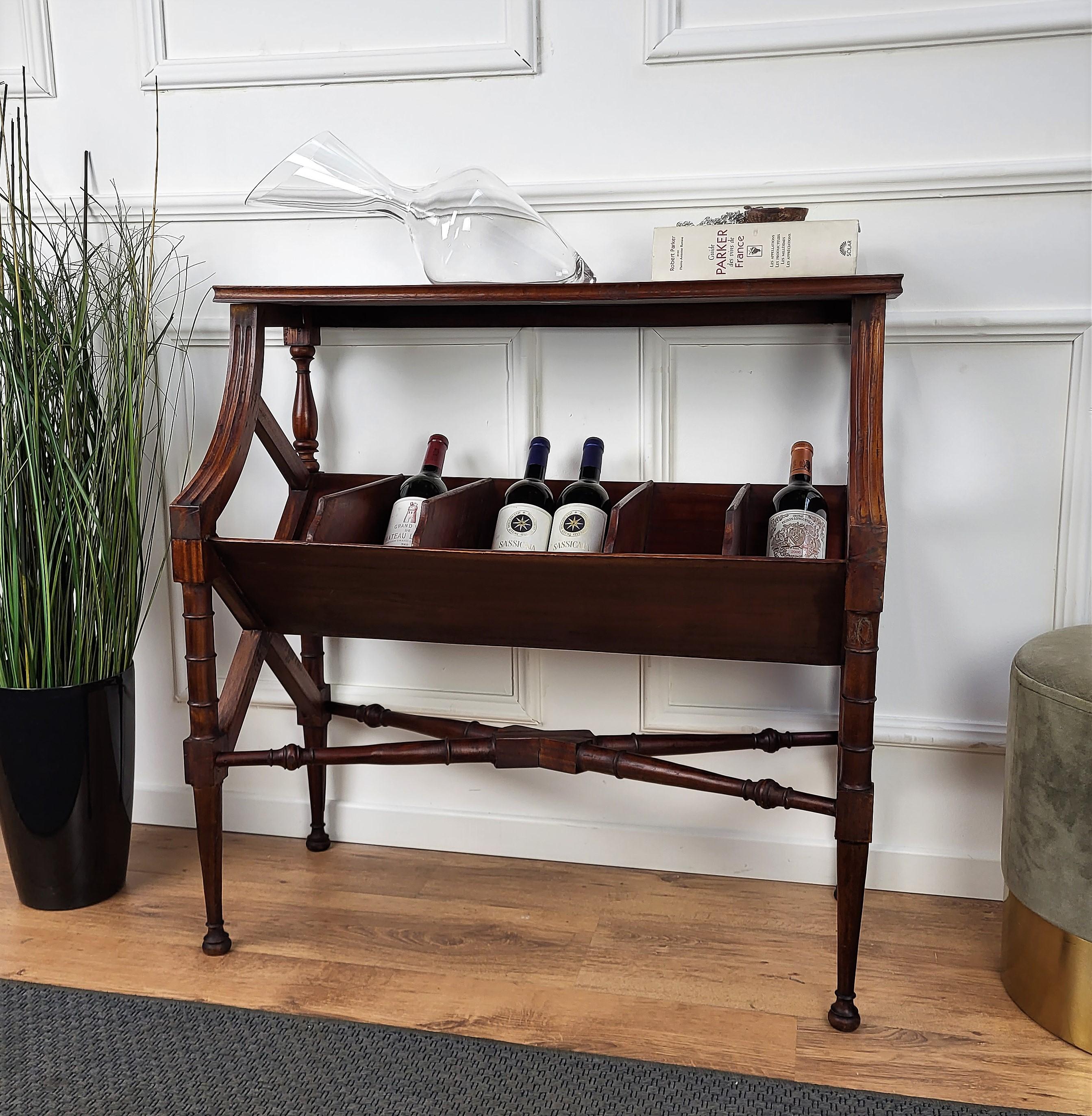 Very elegant Italian wallside table or cabinet, ideal as wine holder dry bar or side table with the various central compartments, completed with beautiful carved legs and connecting stretchers. Its unique and typical design and shapes make this a