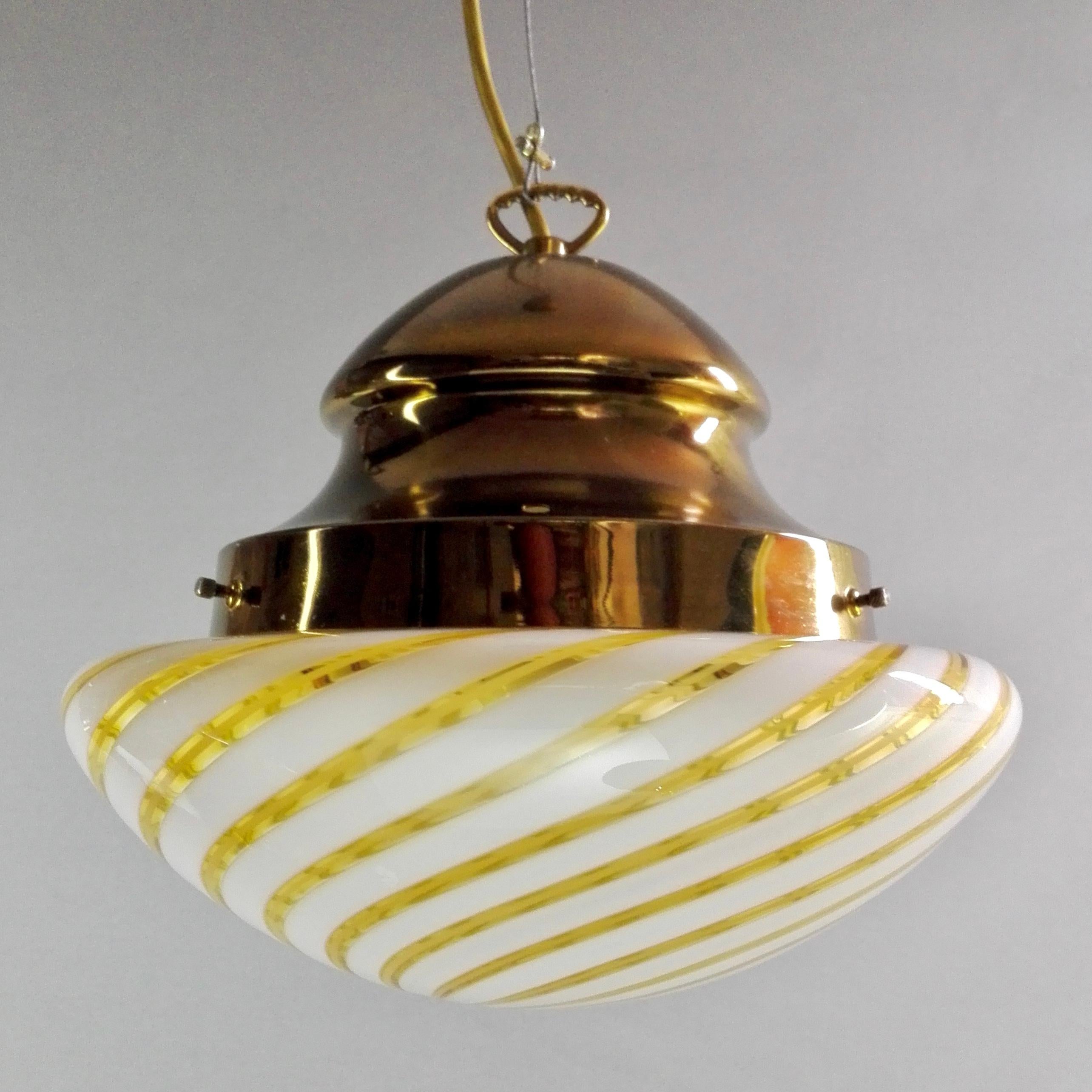 A rare and refined Italian hand-blown Murano glass pendant lamp from the 1960s.
The glass shade features a beautiful white and gold spiral that starts at the bottom and continues in a swirling form to the top. 
There is no trademark on the lamp,