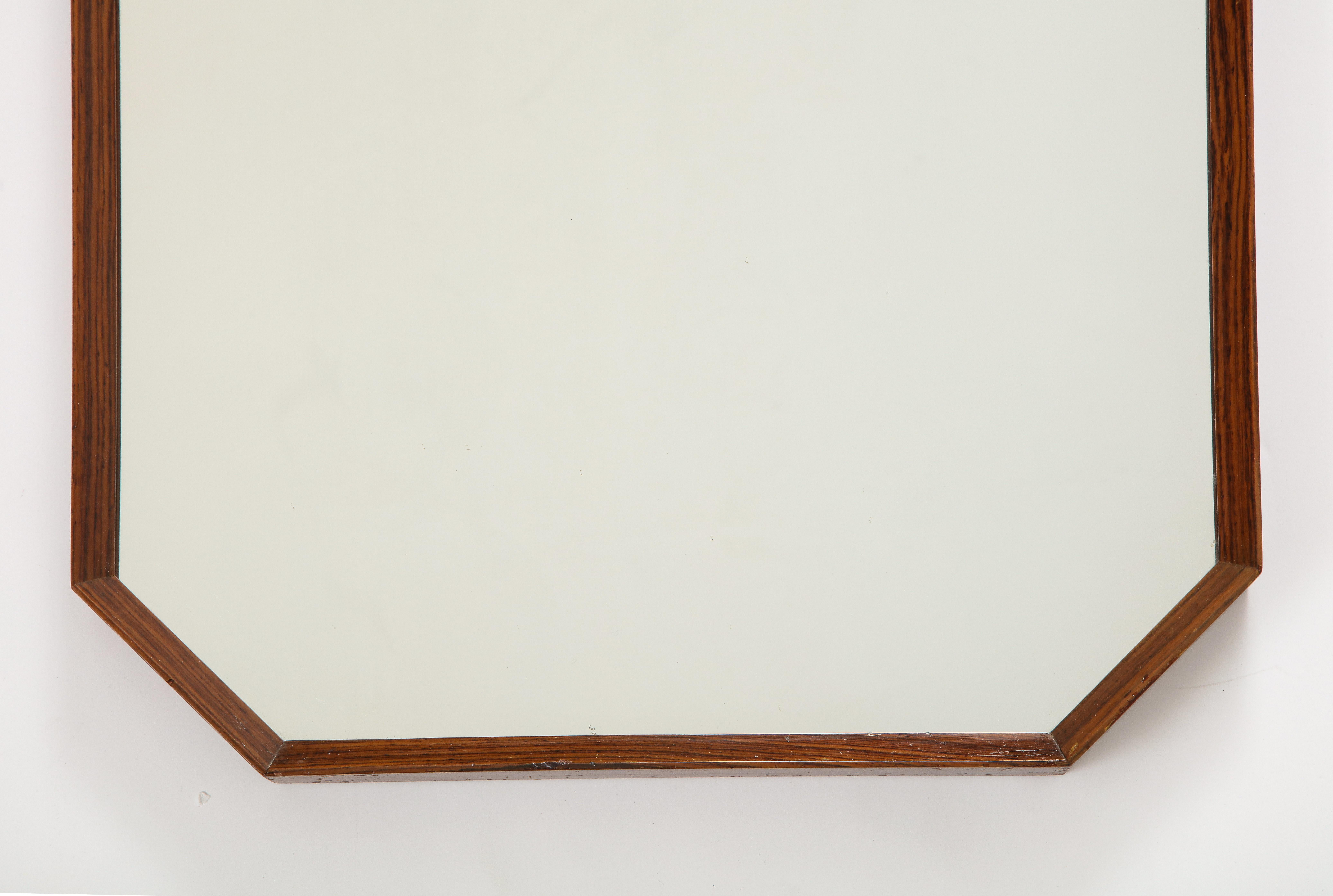 An Italian 1960's rosewood octagonal wall mirror. Very simple and elegant design. 
Italy, circa 1960 
Size: 39 1/4