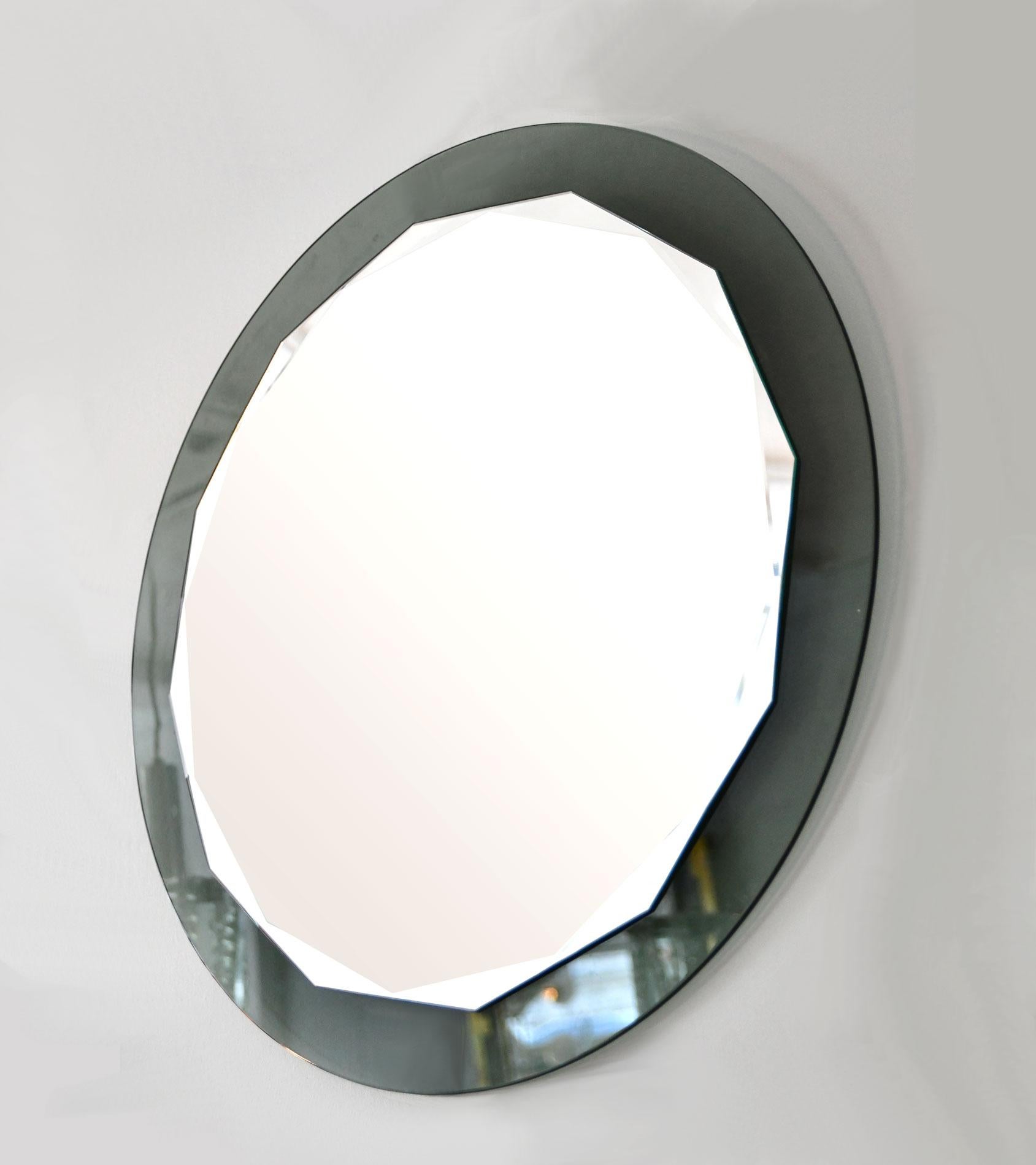 Beautiful wall mirror from the 1960s, made in Italy by Cristal Arte. Round, scalloped faceted mirror with smoked grey mirror backplate glass.