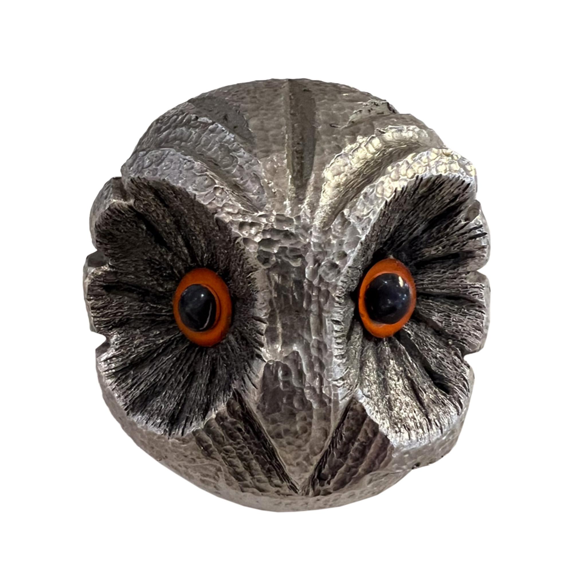 This delightful little owl silvered metal paperweight has gorgeous orange and black glass eyes. 

She or he is surprisingly heavy and is therefore perfect for what s/he was designed for and is of course very decorative. 

A perfect and unique gift