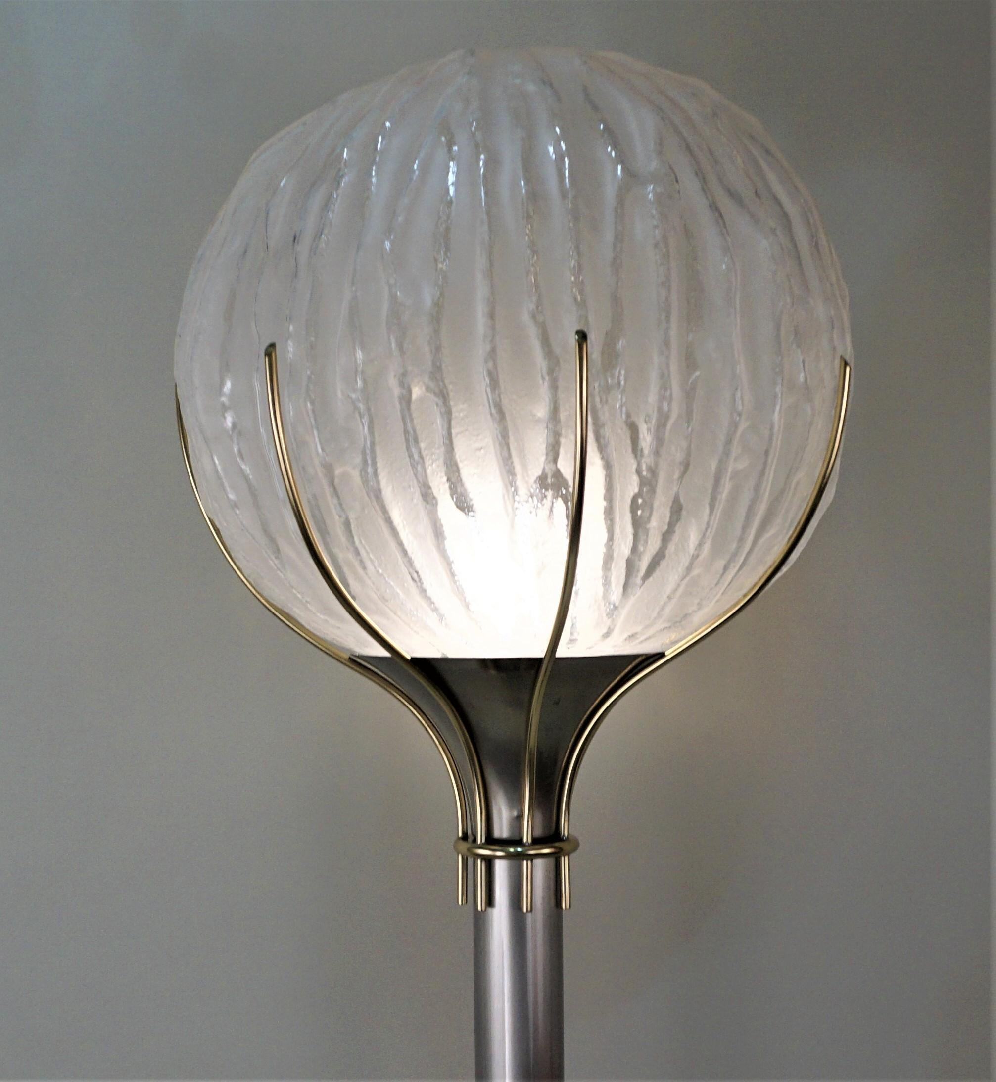 Simple but elegant, a piece sculpture that happens to be a floor lamp. Nickel plate and bronze base with textured blown glass shade.